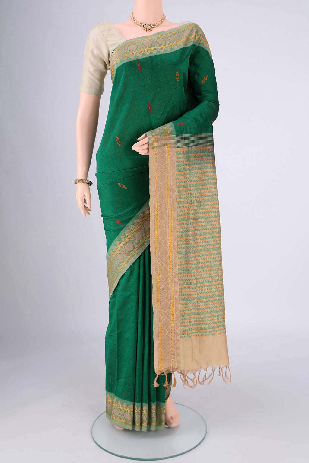 Bottle Green Blended Poly Cotton Saree with Thread Butta on the body and Thread Border.  displayed on a mannequin