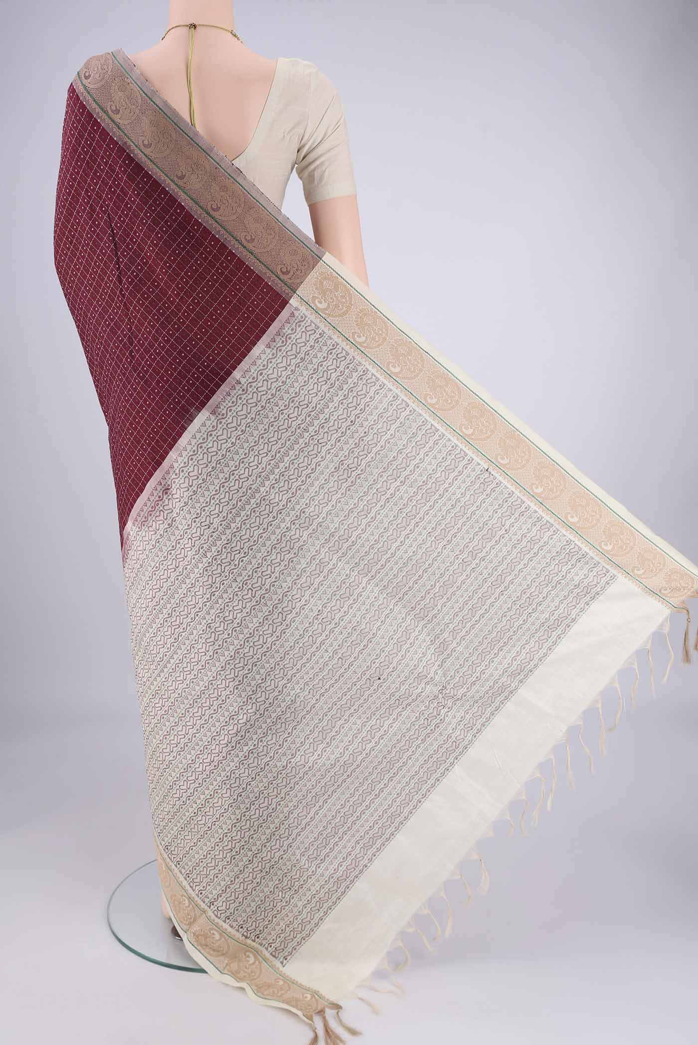 Flat view of Maroon Blended Poly Cotton Saree with Checked design on the body and Thread Border. 