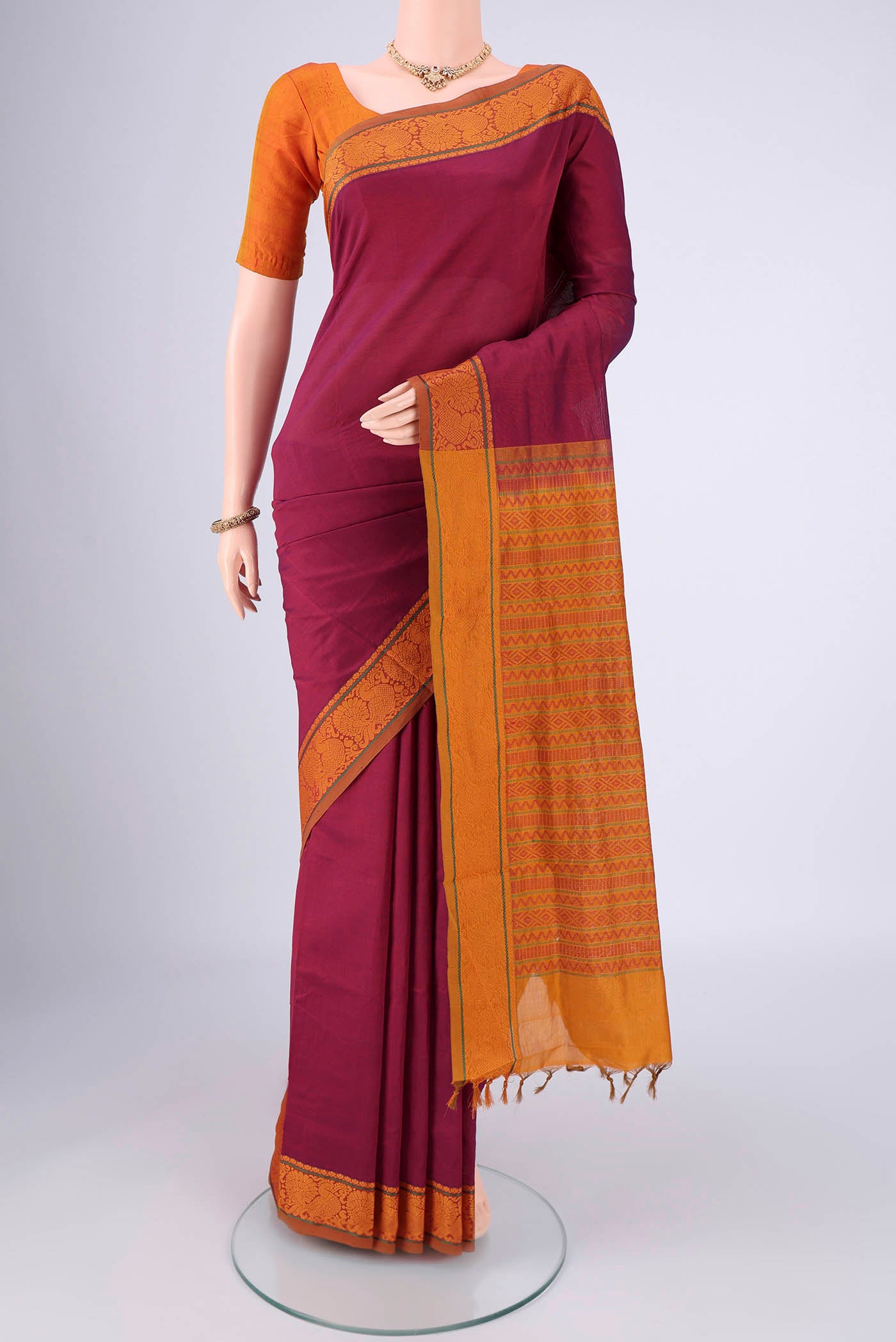 Magenta Blended Poly Cotton Saree with Plain Body and Thread Border.  displayed on a mannequin