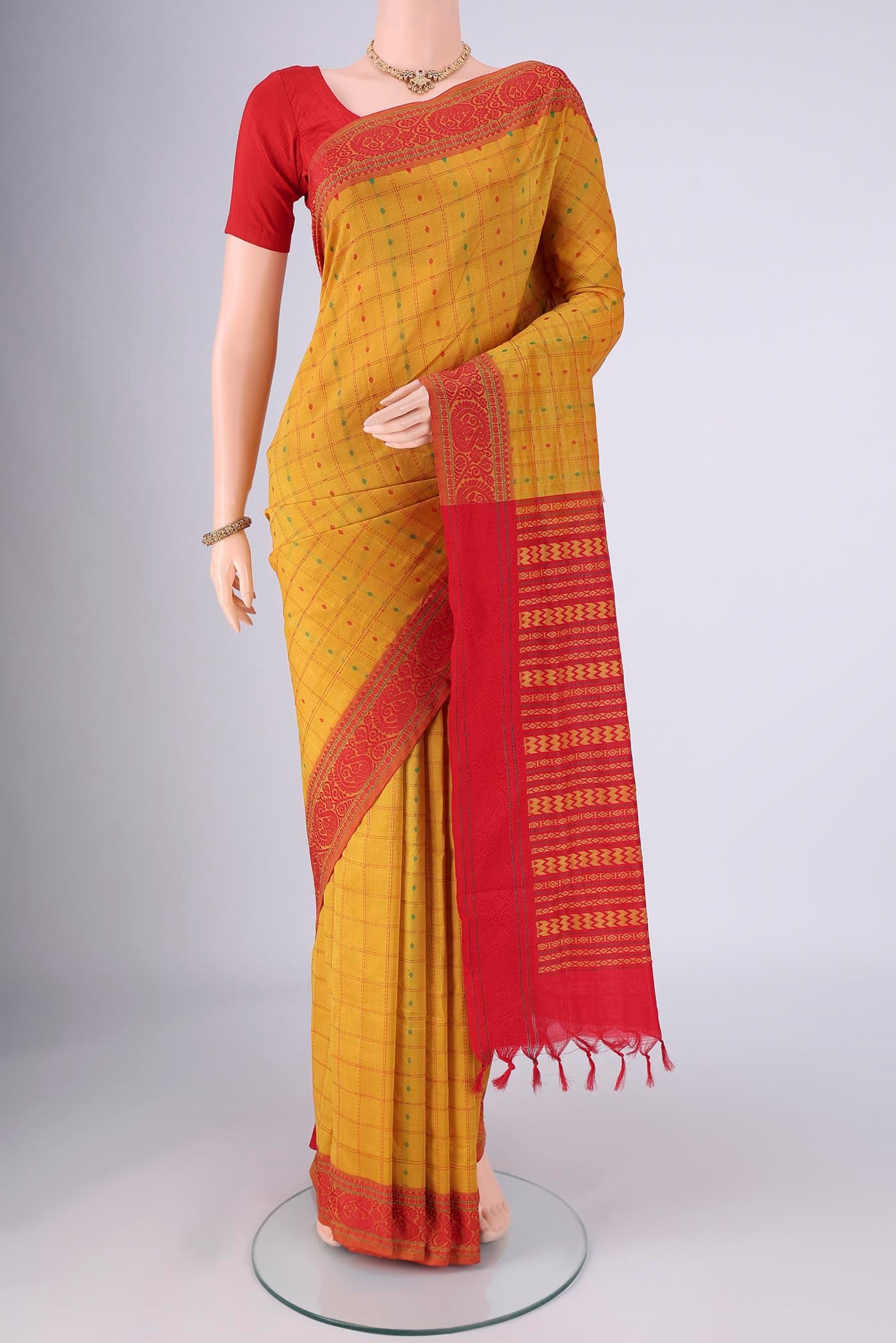 Yellow Blended Poly Cotton Saree with Checked design on the body and Thread Border.  displayed on a mannequin