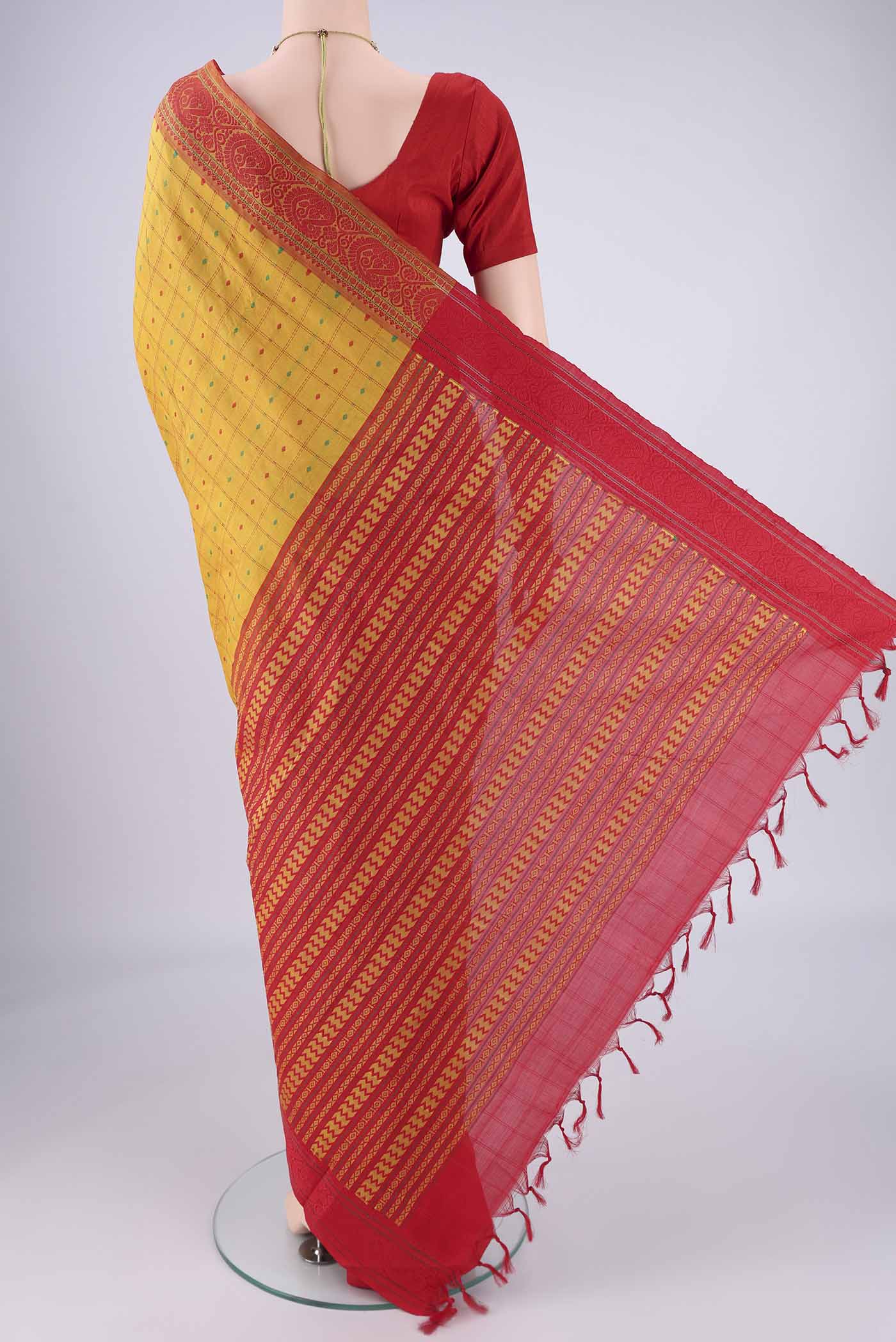 Flat view of Yellow Blended Poly Cotton Saree with Checked design on the body and Thread Border. 
