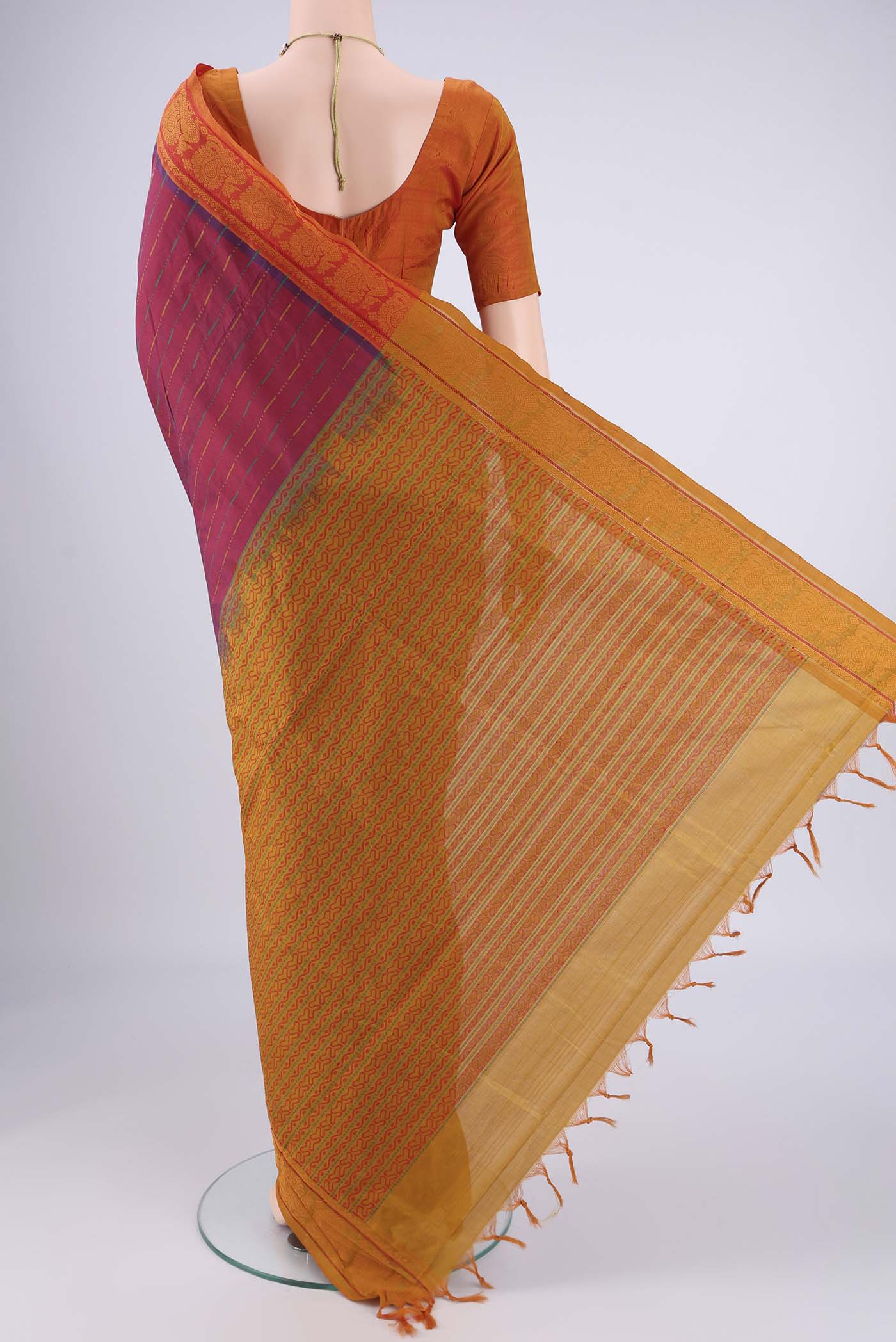 Flat view of Magenta Blended Poly Cotton Saree with Stripes on the body and Thread Border. 