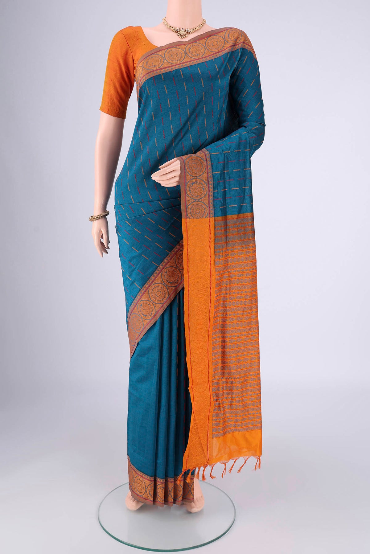 Blue Blended Poly Cotton Saree with Stripes on the body and Thread Border.  displayed on a mannequin