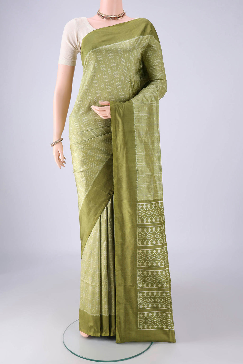 Light Green Pochampally Silk Saree with Checked design on the body and Plain Border.  displayed on a mannequin