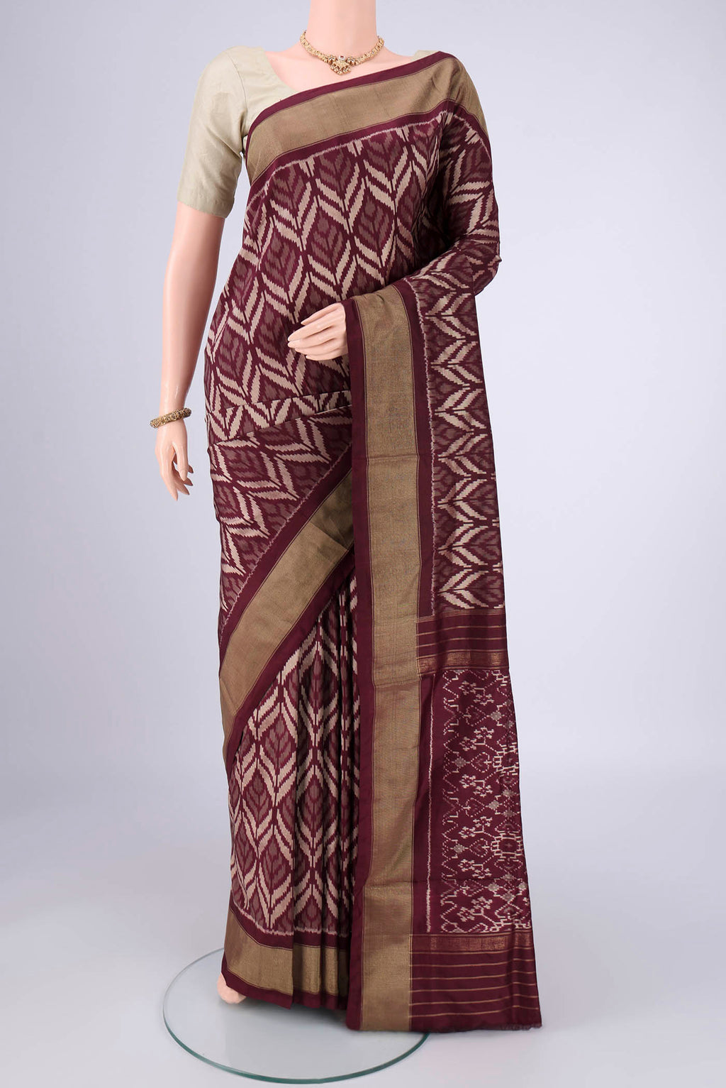 Coffee Brown Pochampally Silk Saree with Ikat design on the body and Zari Border.  displayed on a mannequin