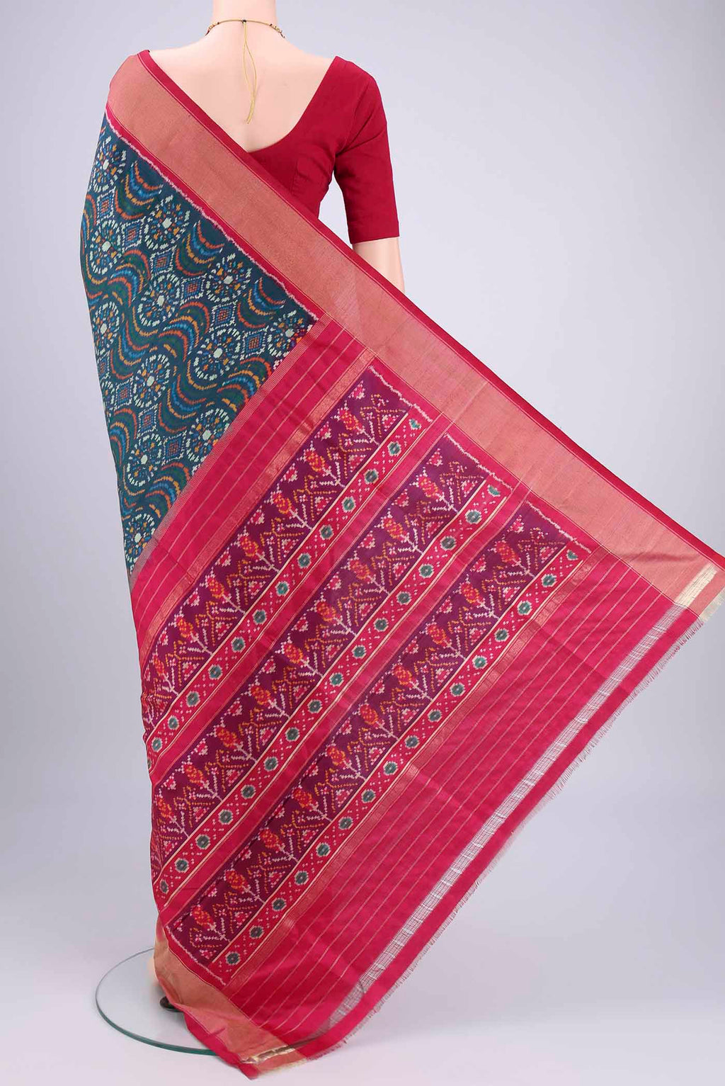 Flat view of Peacock Blue Pochampally Silk Saree with Pure Ikat on the body and Zari Border. 