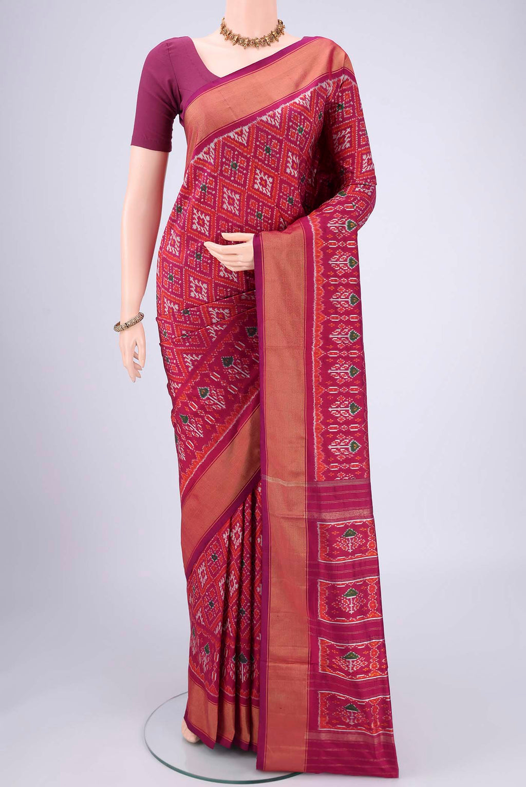Magenta Pochampally Silk Saree with Pure Ikat on the body and Zari Border.  displayed on a mannequin