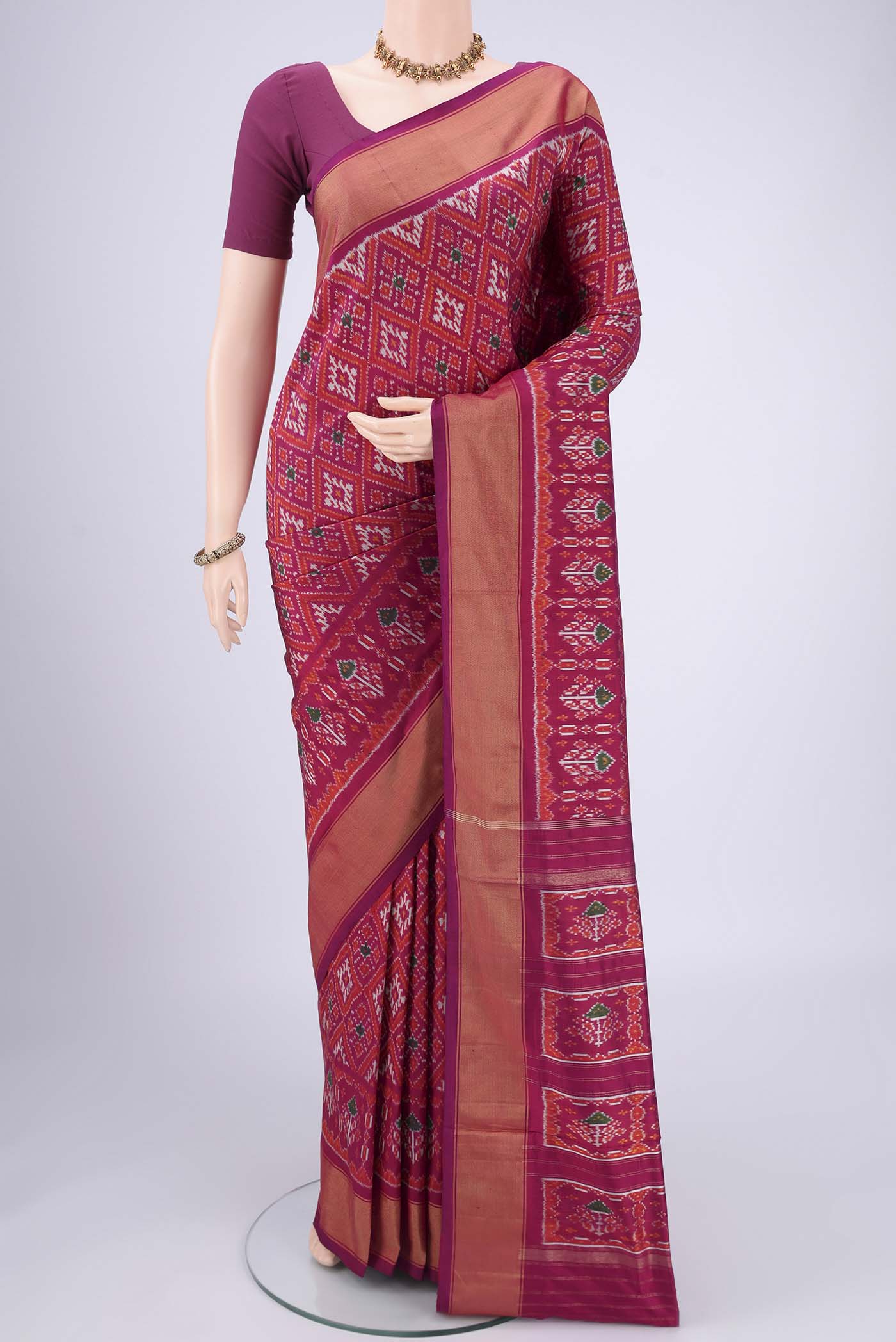Magenta Pochampally Silk Saree with Pure Ikat on the body and Zari Border.  displayed on a mannequin