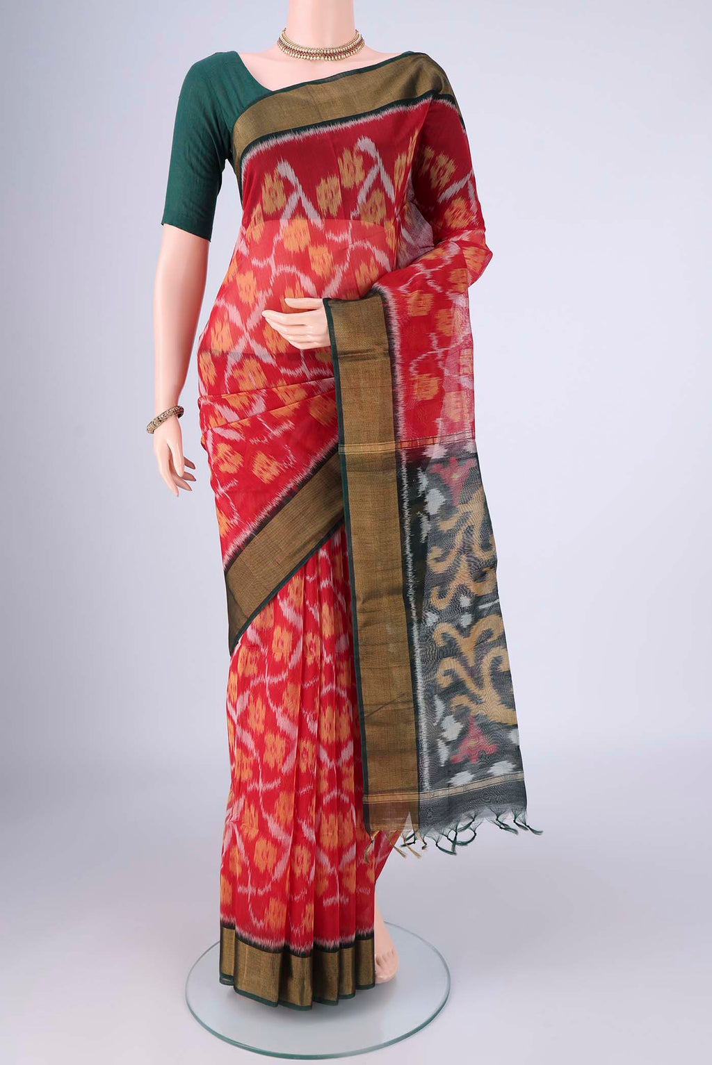 Red Silk Cotton Saree with Ikat design on the body and Zari Border.  displayed on a mannequin