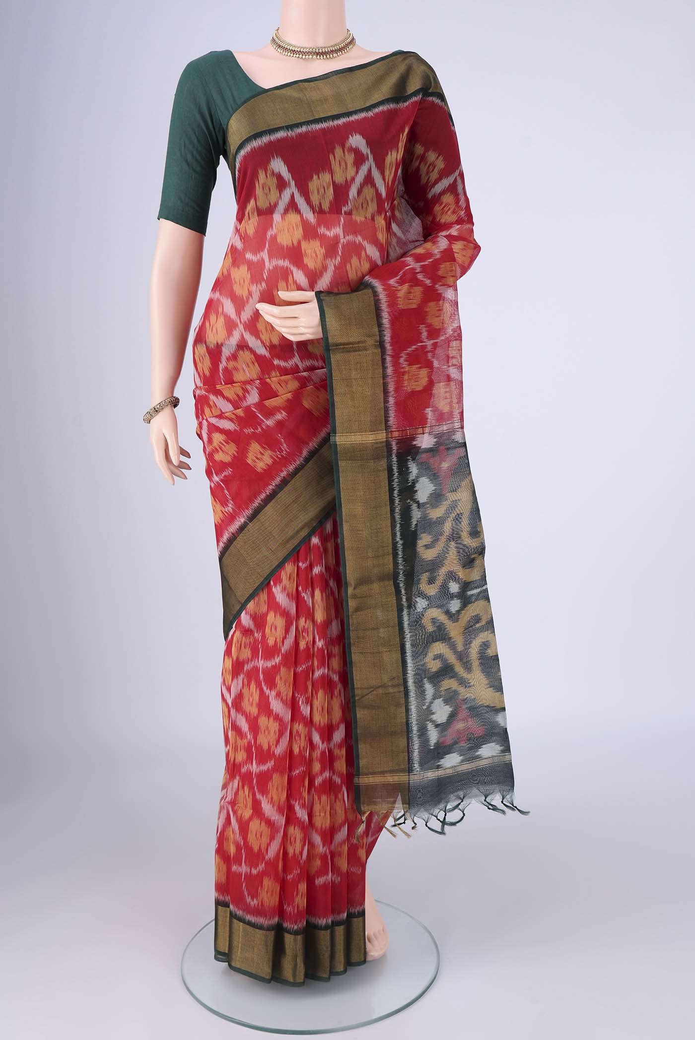 Red Silk Cotton Saree with Ikat design on the body and Zari Border.  displayed on a mannequin