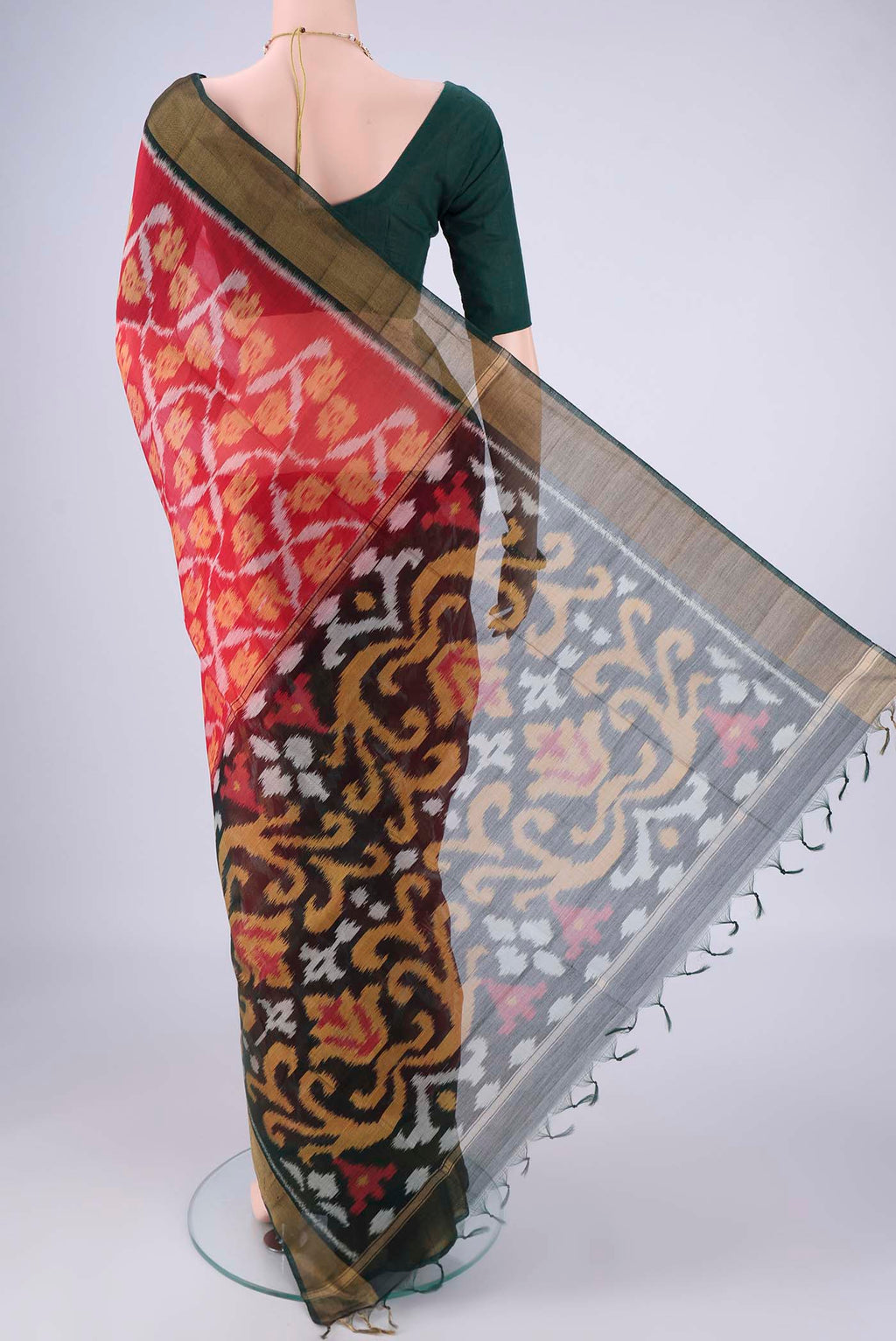 Flat view of Red Silk Cotton Saree with Ikat design on the body and Zari Border. 