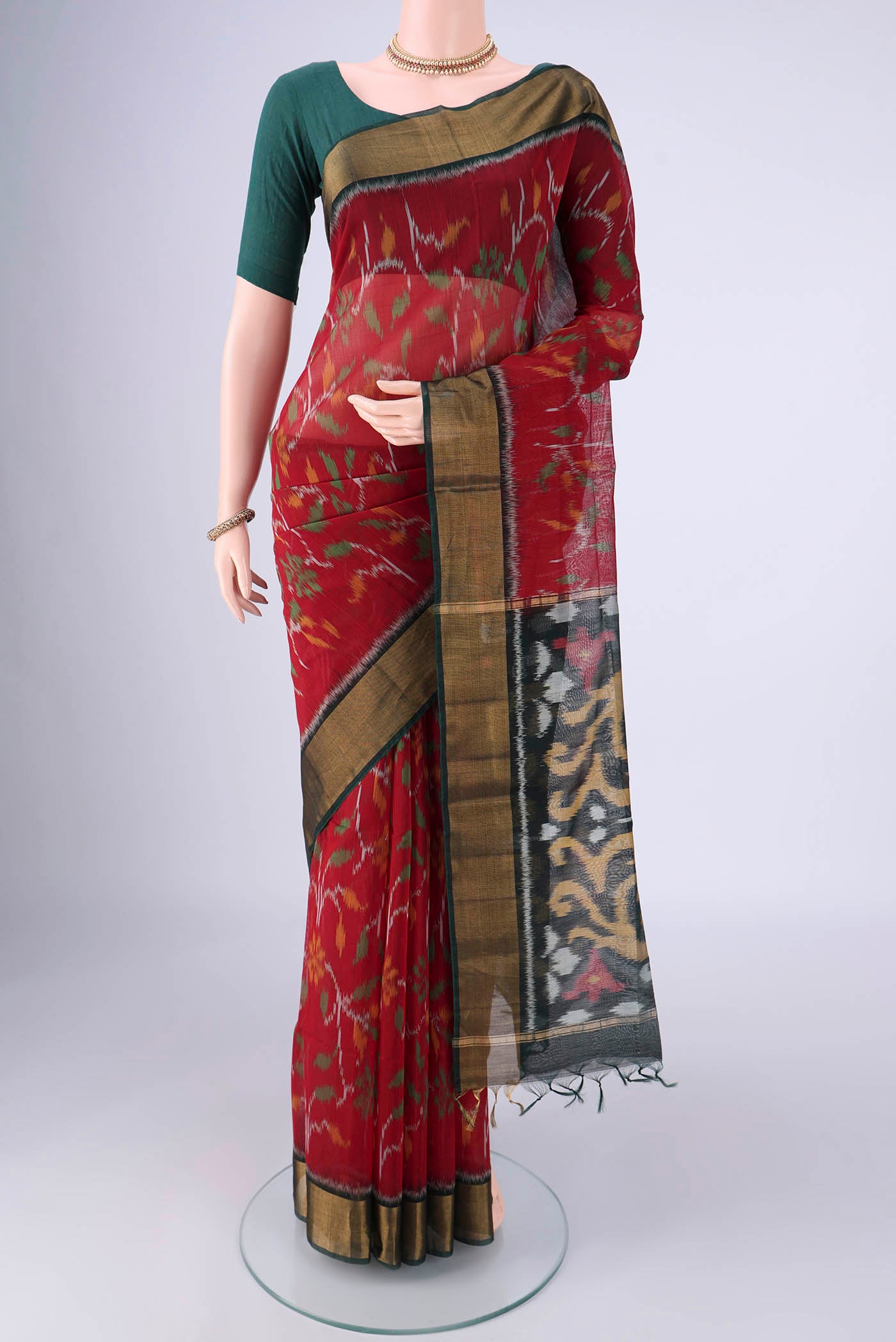 Maroon Silk Cotton Saree with Ikat design on the body and Zari Border.  displayed on a mannequin