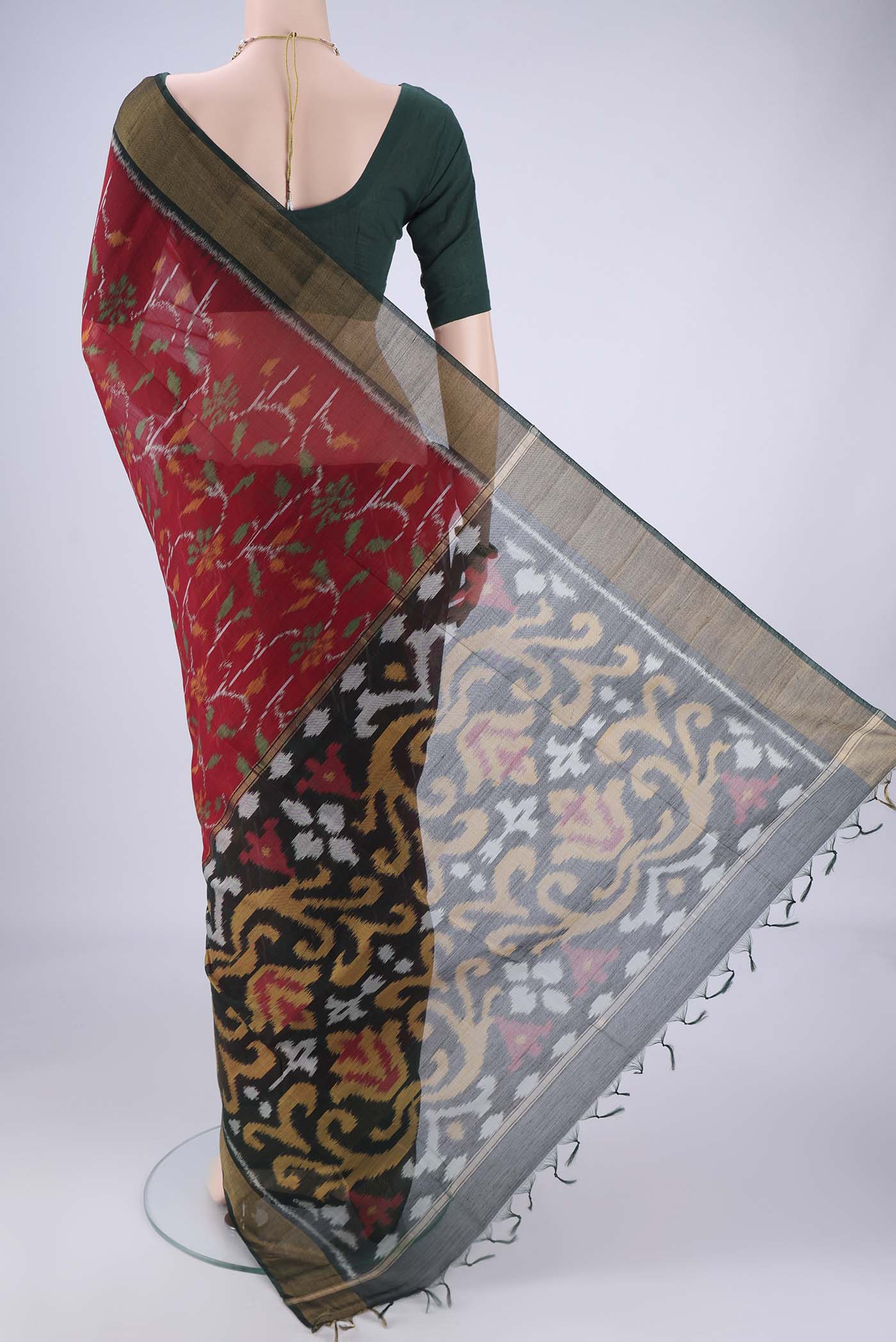 Flat view of Maroon Silk Cotton Saree with Ikat design on the body and Zari Border. 