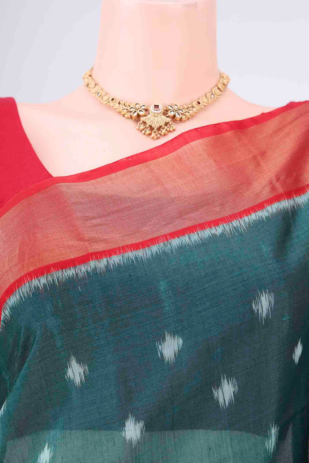 Border image of Green Kora Cotton Saree with Ikat design on the body and Zari Border. 