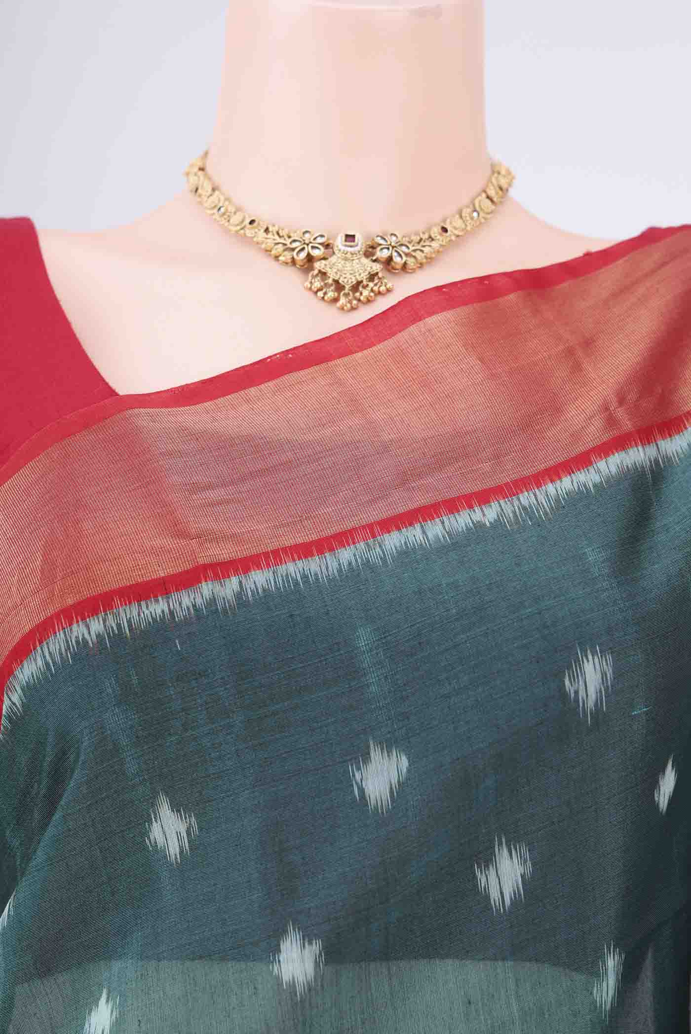 Border image of Green Kora Cotton Saree with Ikat design on the body and Zari Border. 