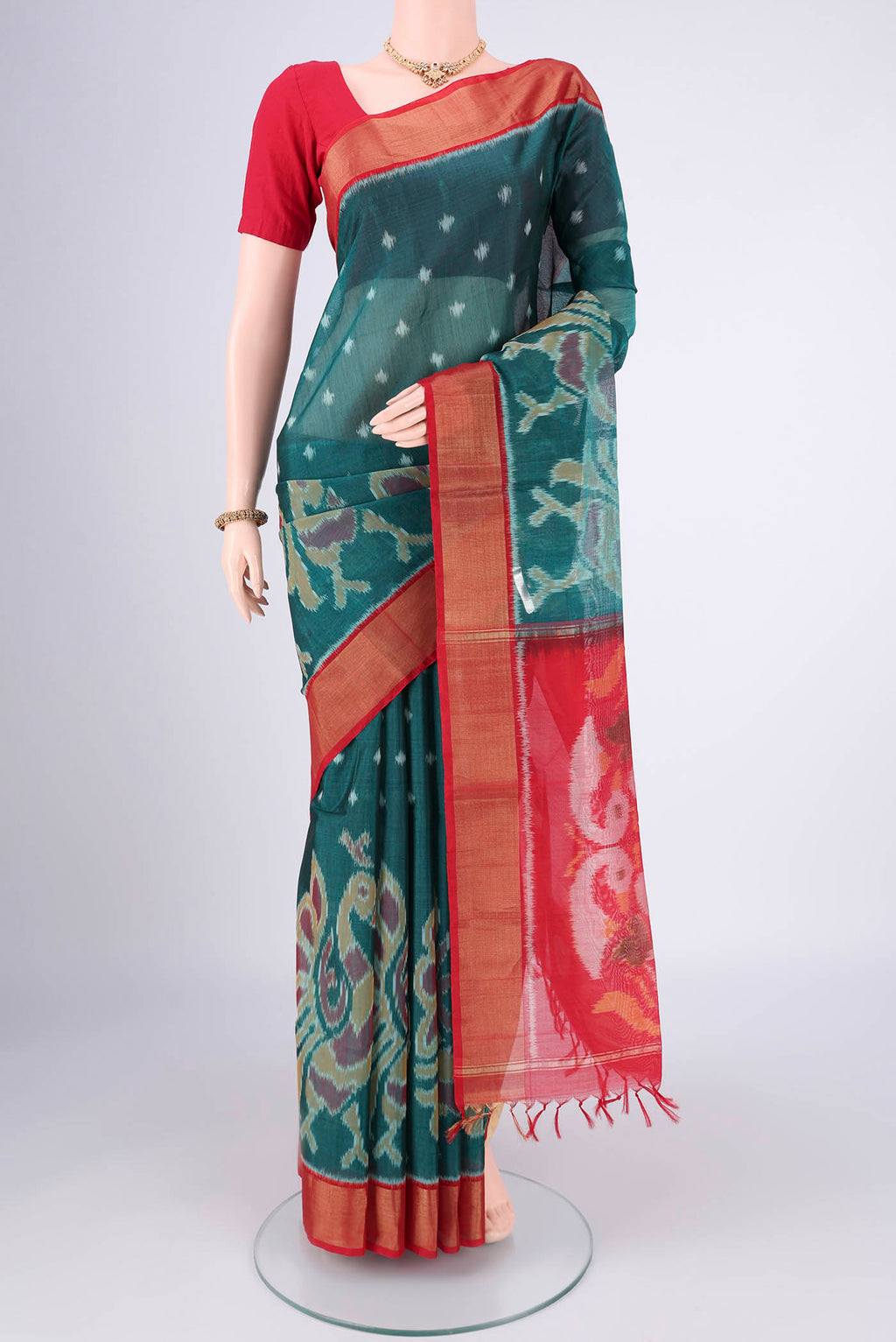 Green Kora Cotton Saree with Ikat design on the body and Zari Border.  displayed on a mannequin
