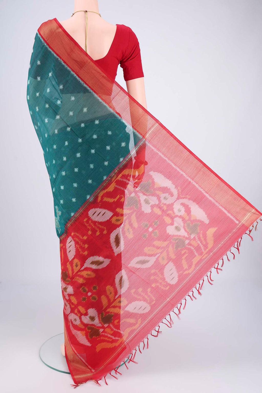Flat view of Green Kora Cotton Saree with Ikat design on the body and Zari Border. 