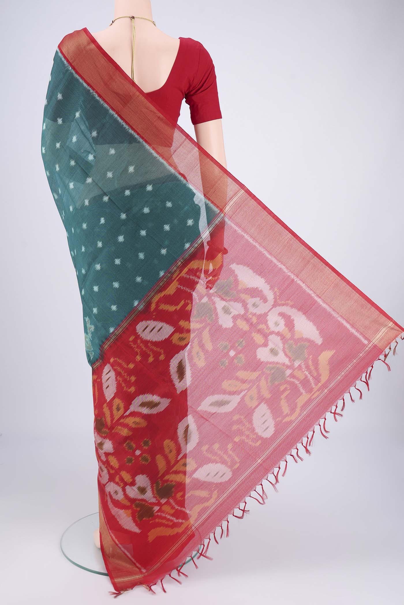Flat view of Green Kora Cotton Saree with Ikat design on the body and Zari Border. 