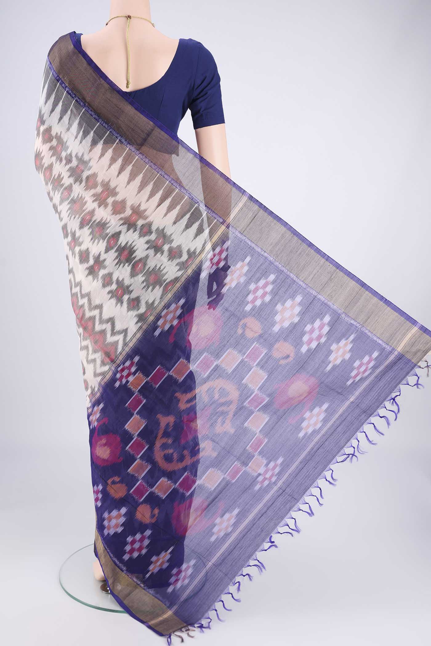 Flat view of Off White Kora Cotton Saree with Ikat design on the body and Zari Border. 