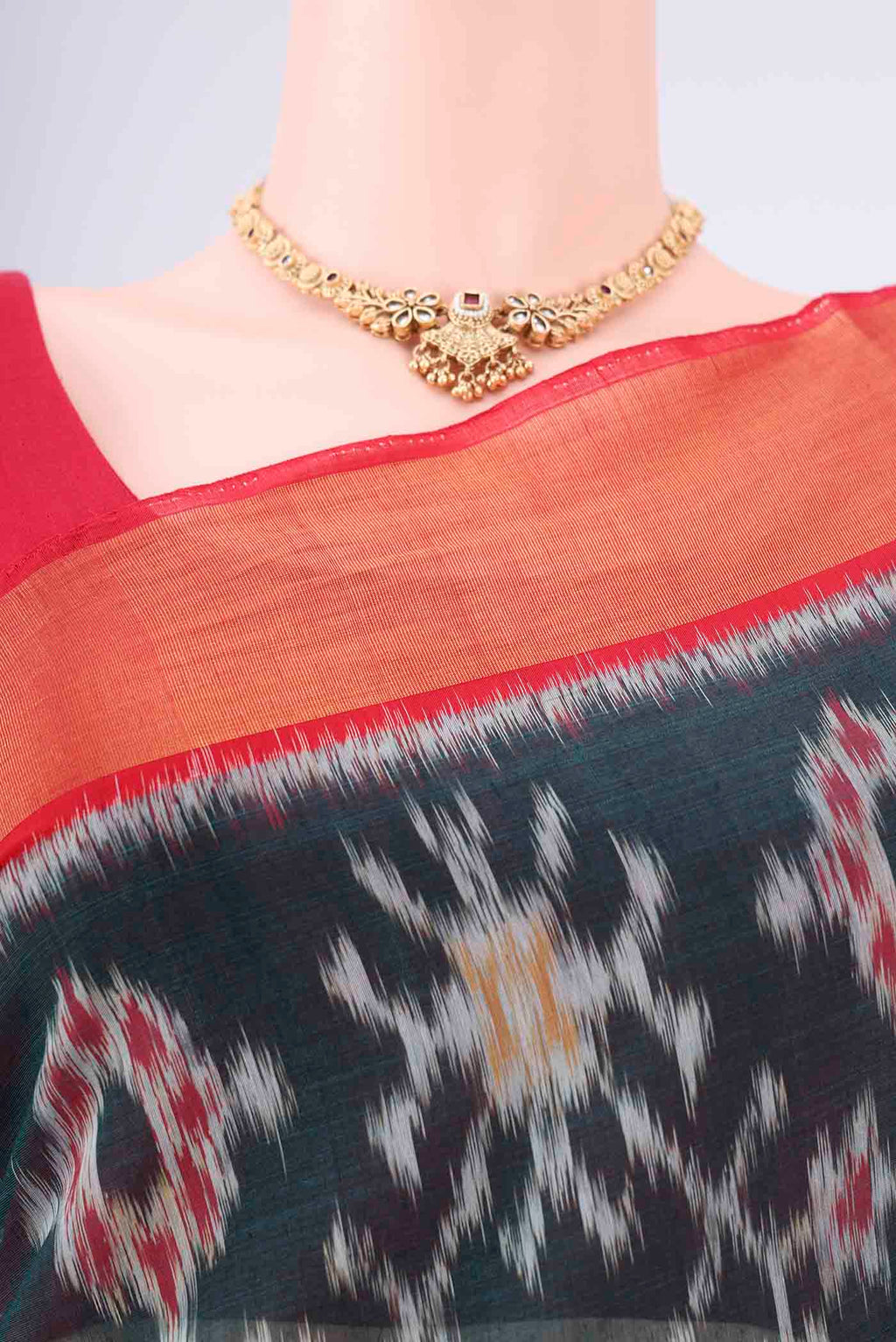 Border image of Bottle Green Kora Cotton Saree with Ikat design on the body and Zari Border. 
