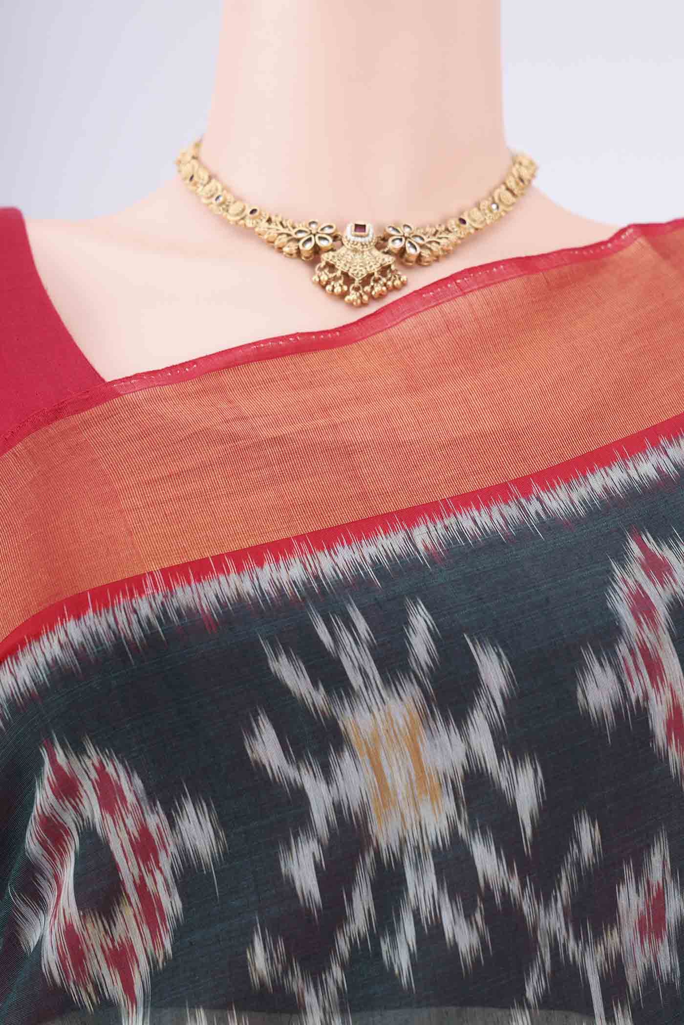 Border image of Bottle Green Kora Cotton Saree with Ikat design on the body and Zari Border. 