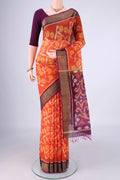 Brick Orange Silk Cotton Saree with Ikat design on the body and Zari Border.  displayed on a mannequin