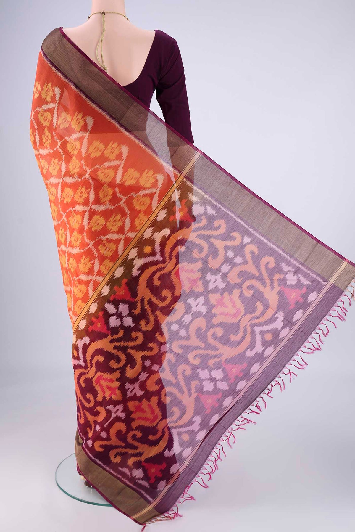 Flat view of Brick Orange Silk Cotton Saree with Ikat design on the body and Zari Border. 