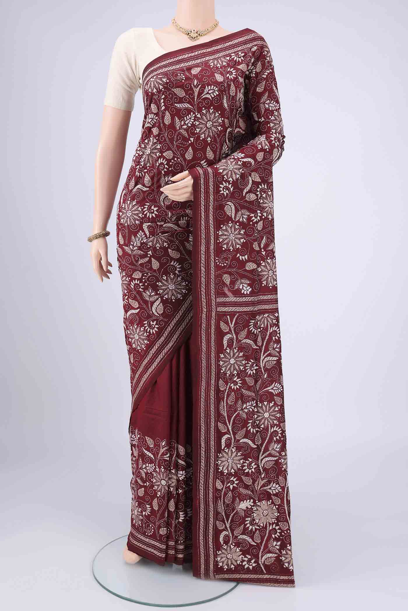 Maroon Kantha Silk Saree with Kantha Work on the body and Thread Border.  displayed on a mannequin