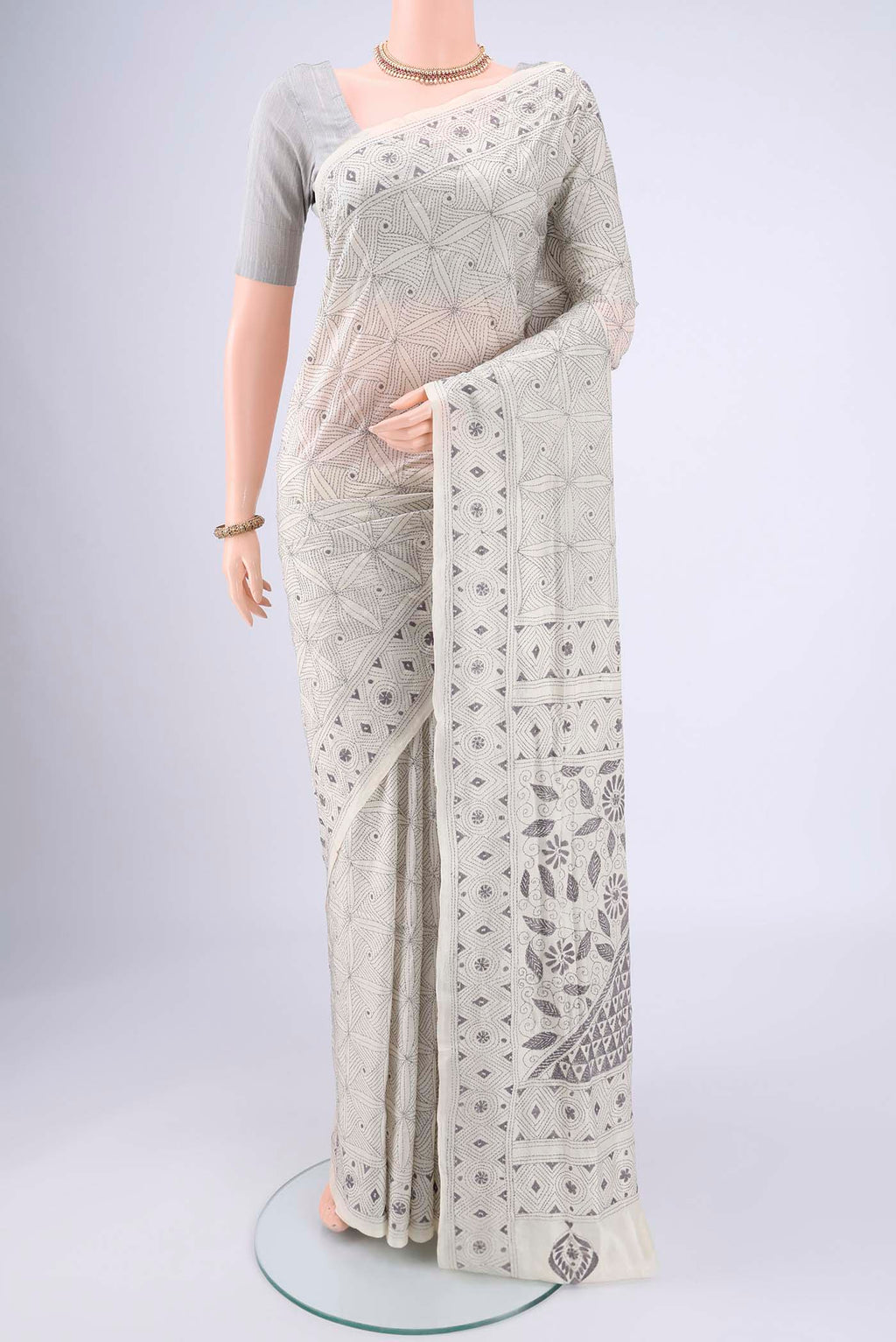 White Kantha Silk Saree with Kantha Work on the body and Thread Border.  displayed on a mannequin