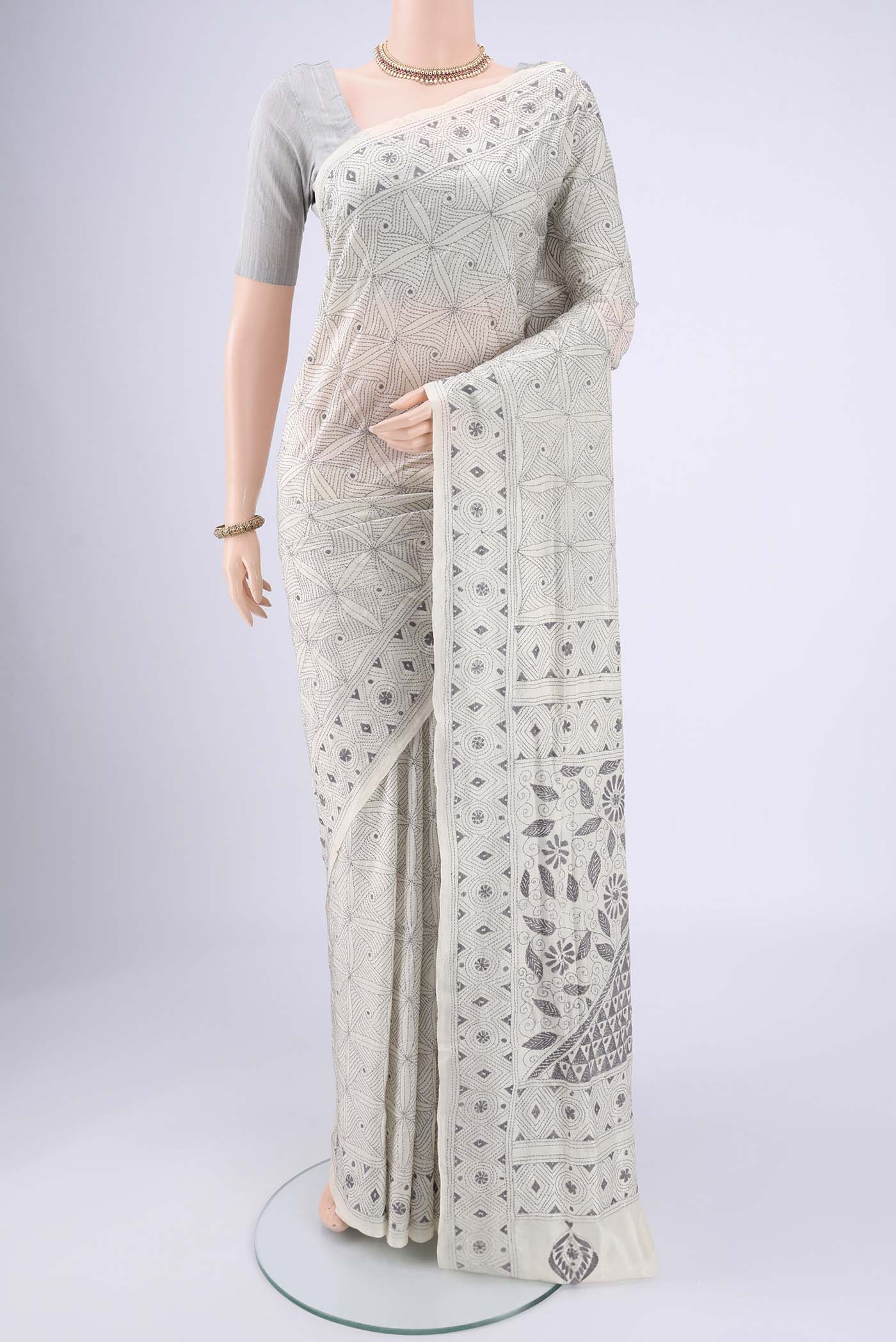 White Kantha Silk Saree with Kantha Work on the body and Thread Border.  displayed on a mannequin