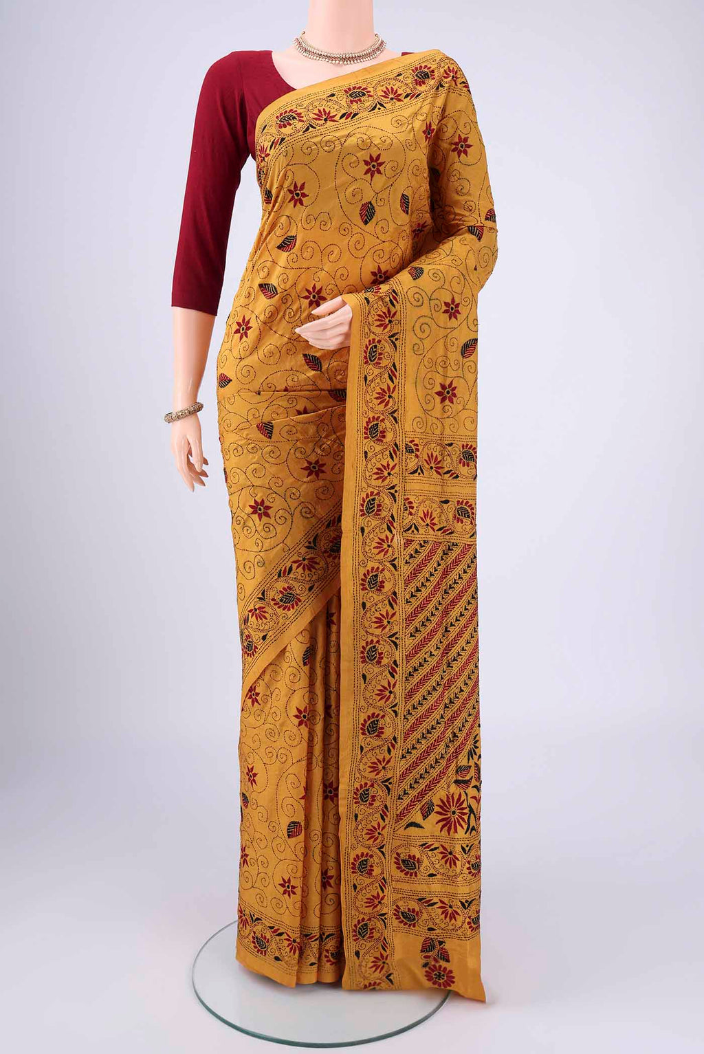 Mustard Kantha Silk Saree with Kantha Work on the body and Thread Border.  displayed on a mannequin