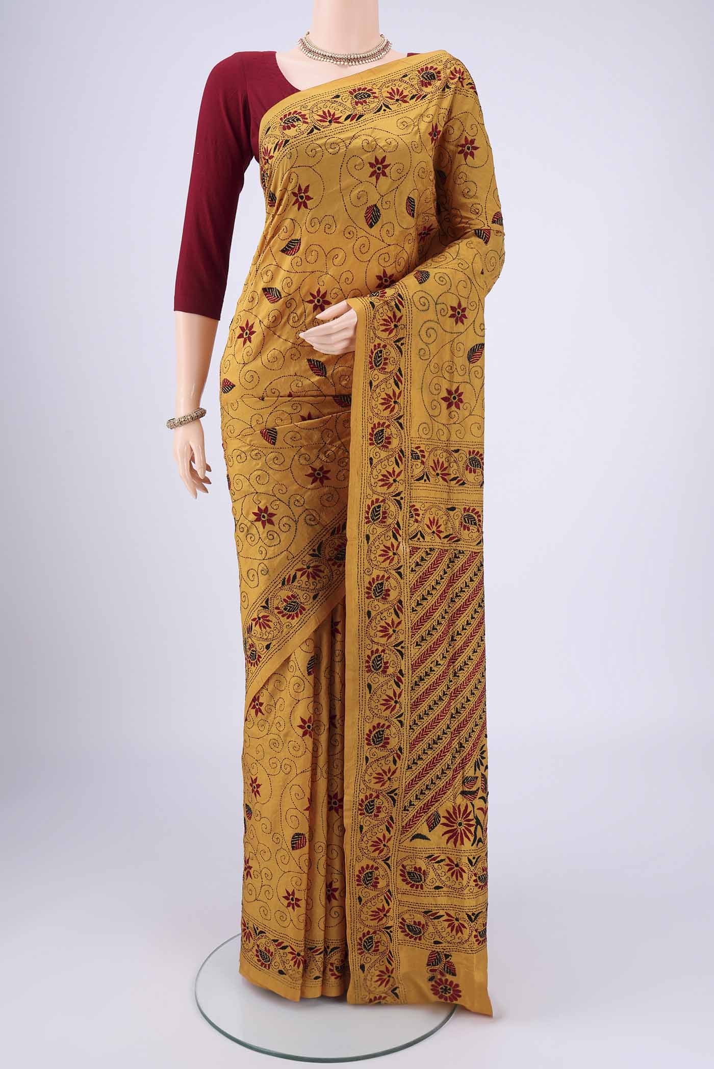 Mustard Kantha Silk Saree with Kantha Work on the body and Thread Border.  displayed on a mannequin