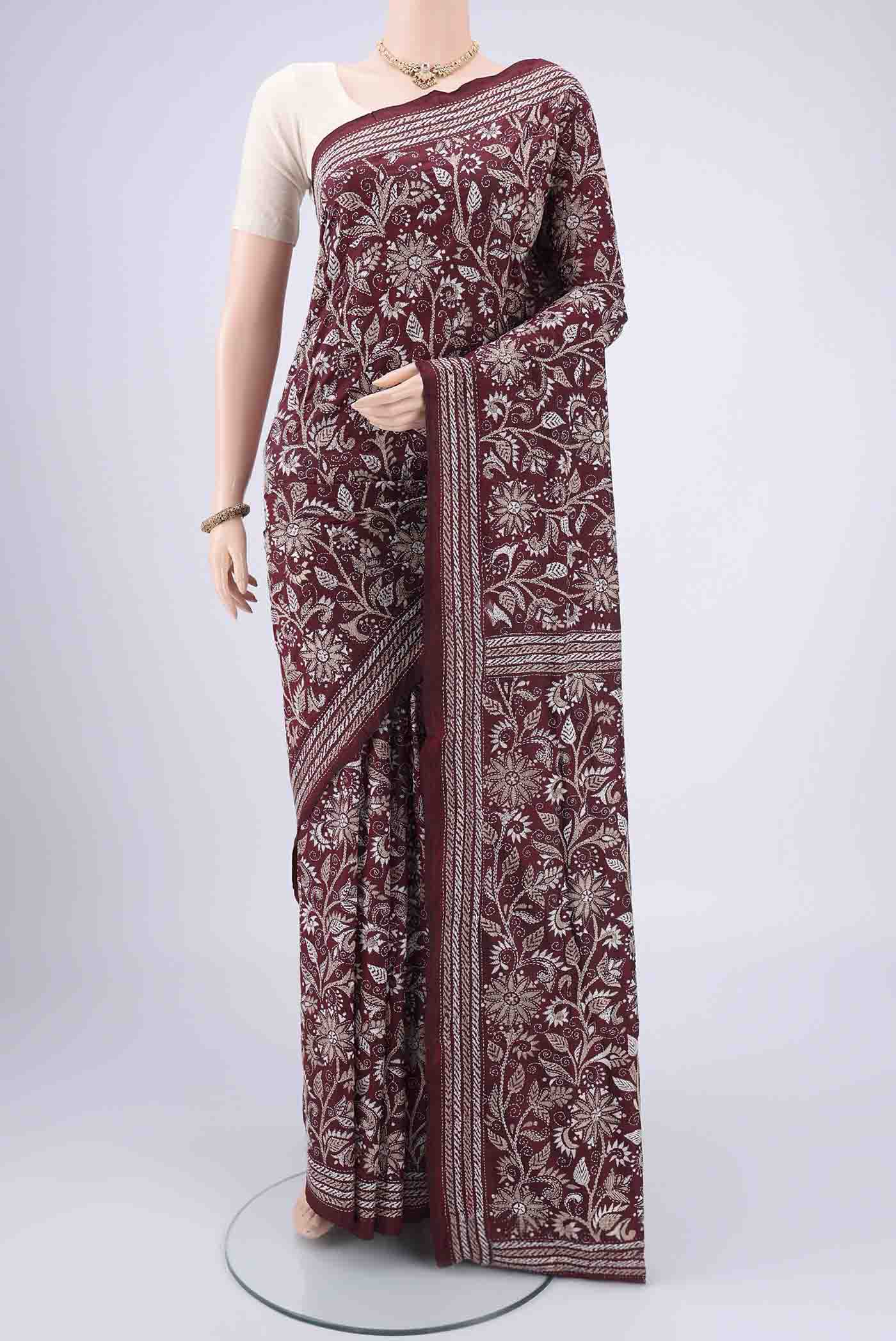 Maroon Kantha Silk Saree with Kantha Work on the body and Thread Border.  displayed on a mannequin
