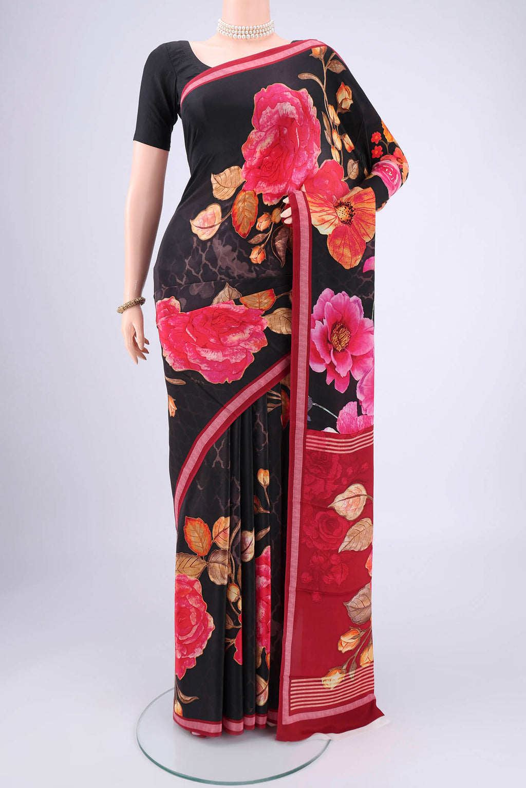 Black Mysore Crepe Saree with Floral Print on the body and Zari Border.  displayed on a mannequin