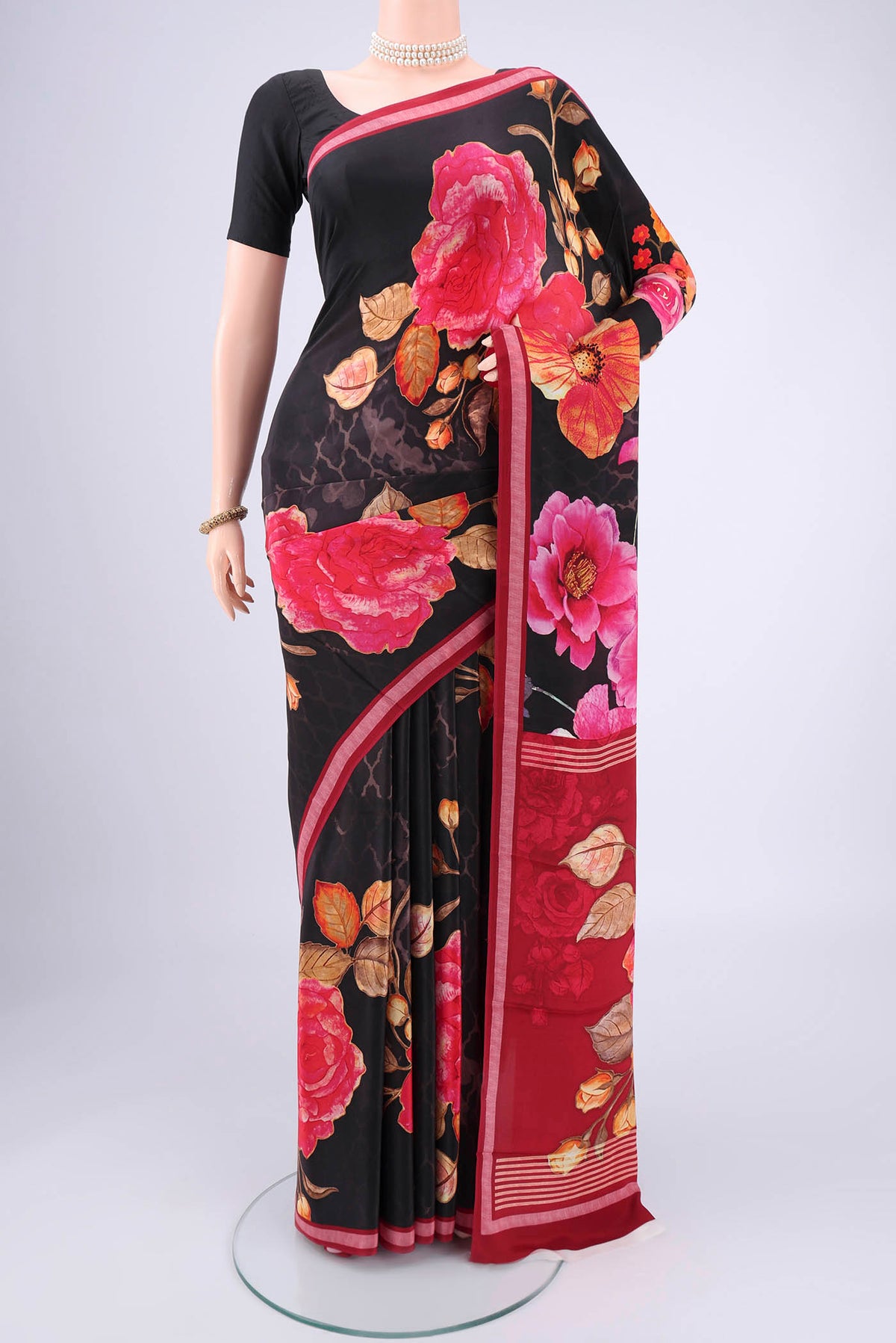 Black Mysore Crepe Saree with Floral Print on the body and Zari Border.  displayed on a mannequin