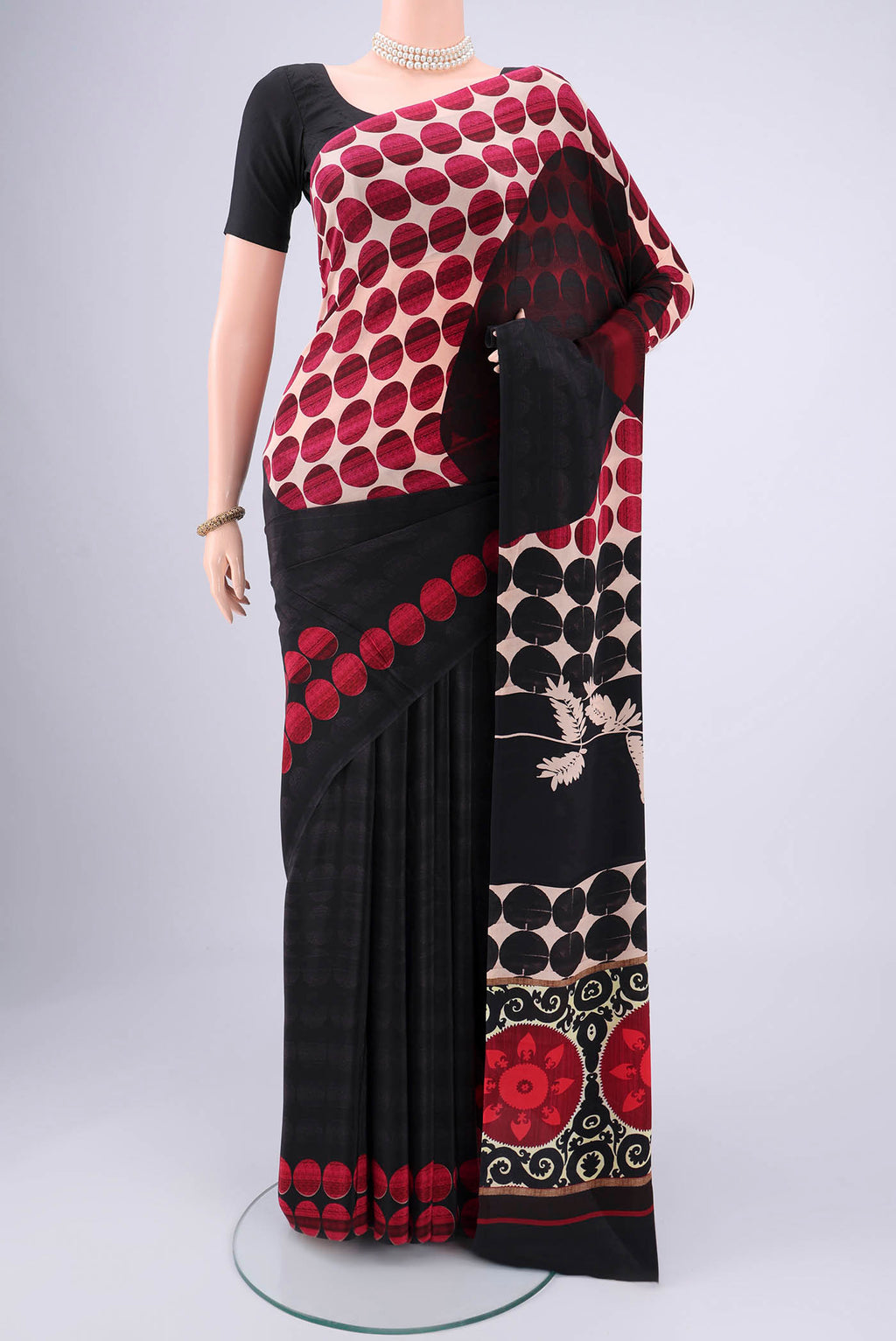 Black Mysore Crepe Saree with Floral Print on the body and Zari Border.  displayed on a mannequin
