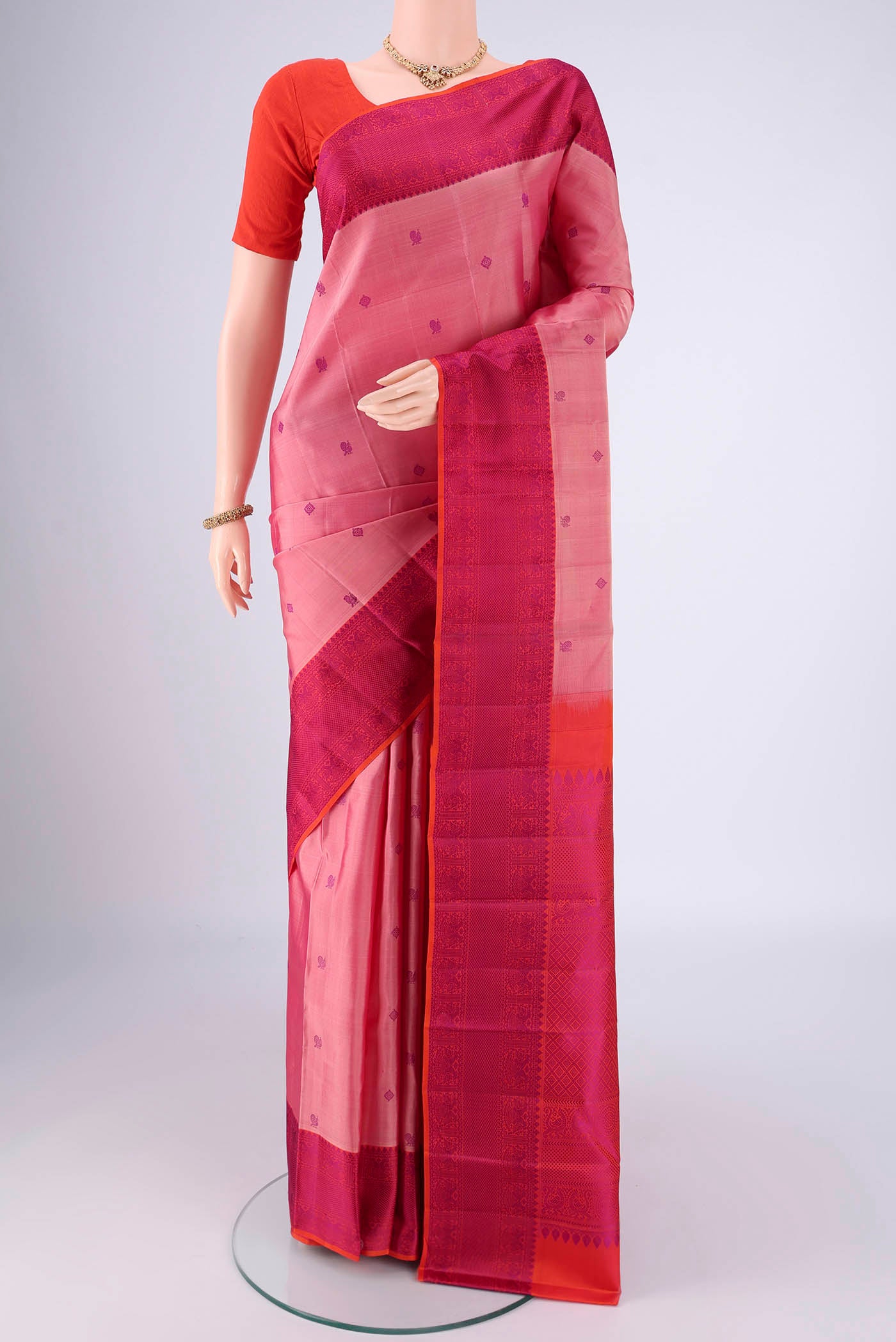 Rose pink Dual Tone Kanchipuram Saree with Thread Butta on the body and Thread Border.  displayed on a mannequin
