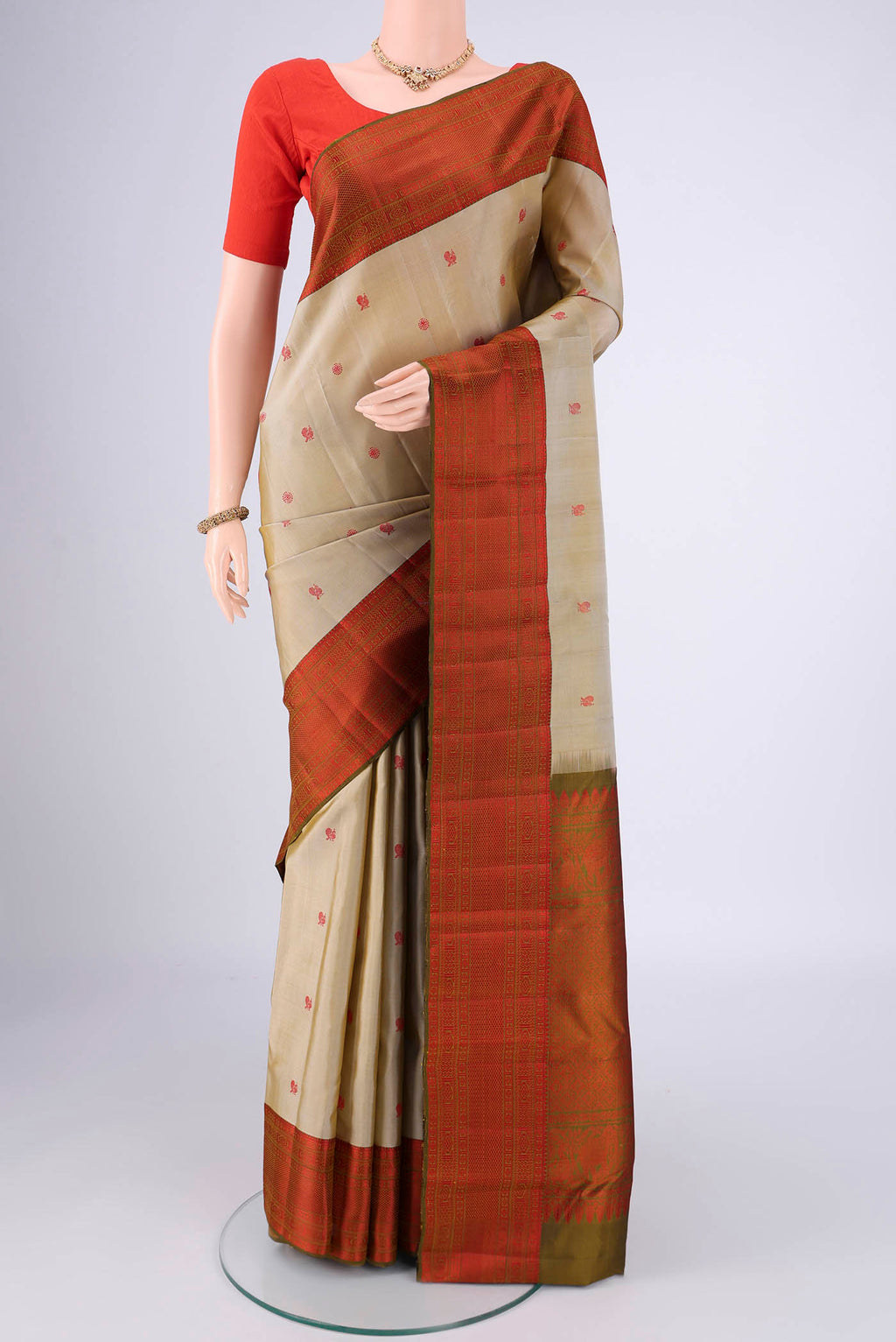 Dark Beige Dual Tone Kanchipuram Saree with Thread Butta on the body and Thread Border.  displayed on a mannequin