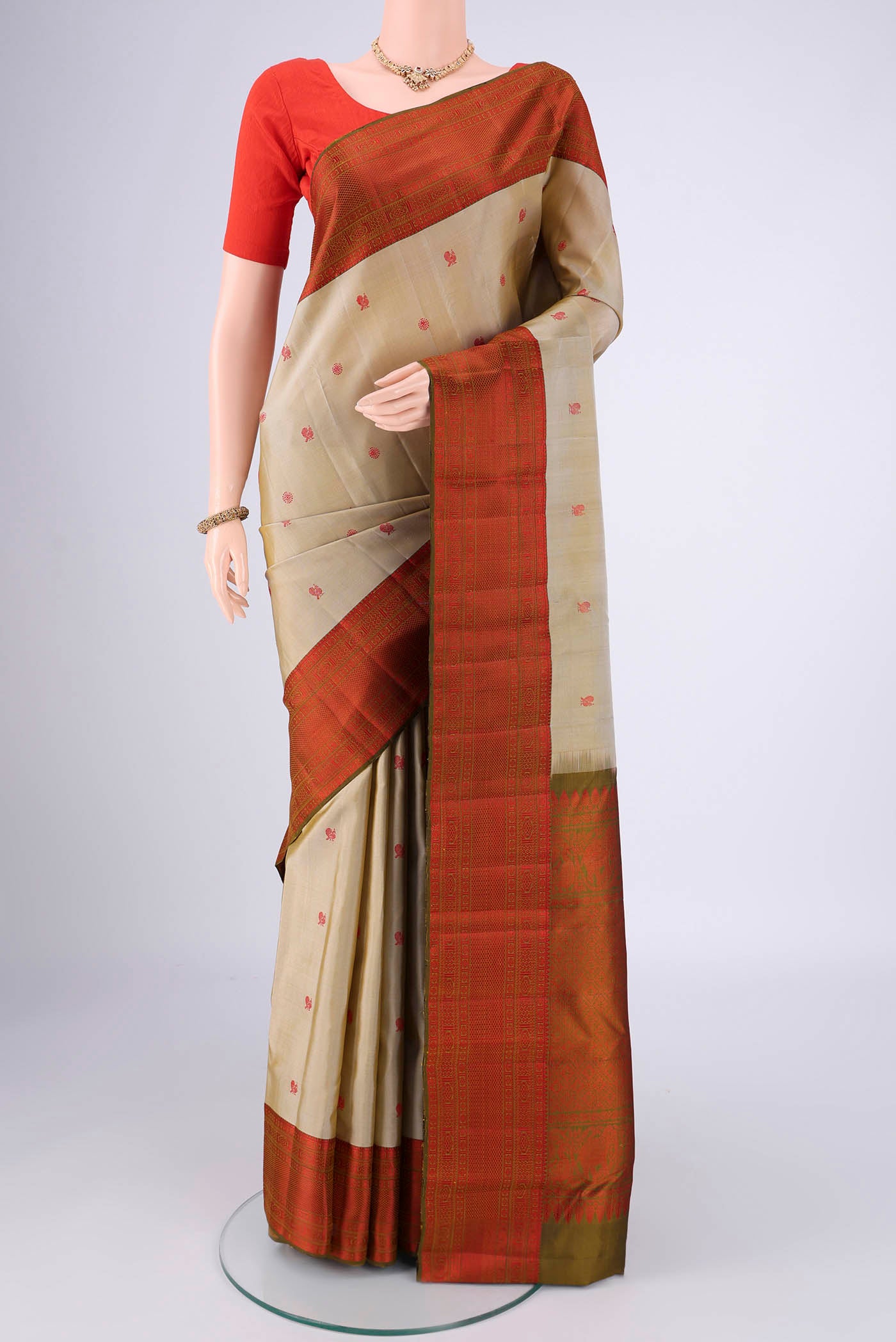 Dark Beige Dual Tone Kanchipuram Saree with Thread Butta on the body and Thread Border.  displayed on a mannequin