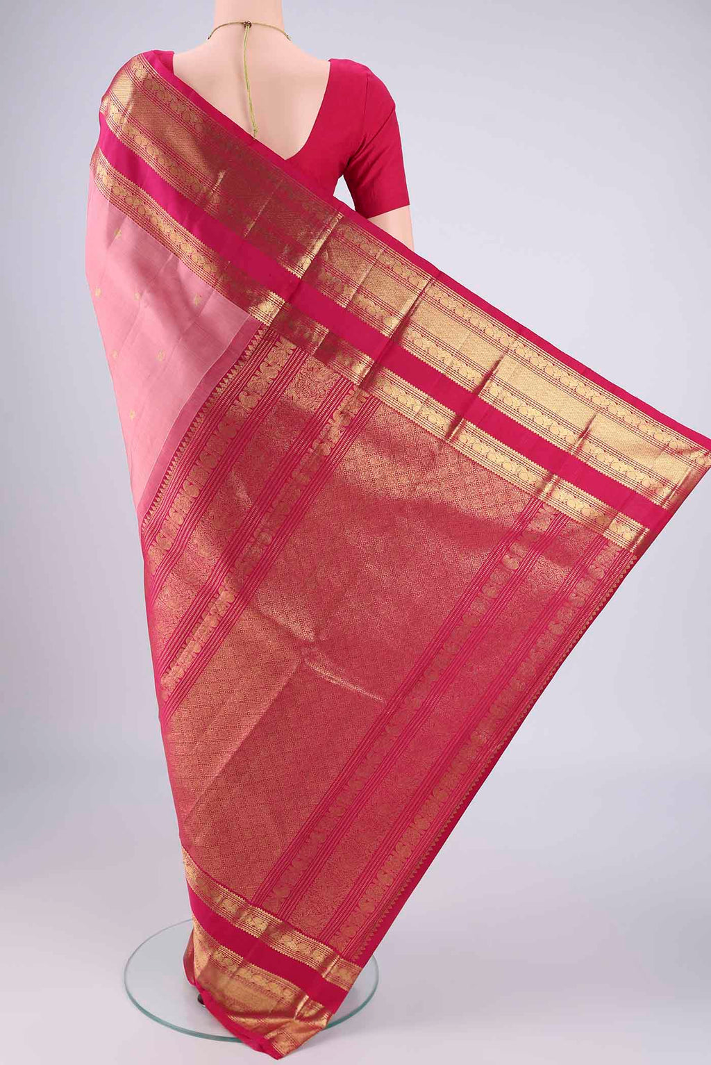 Flat view of Rose Gold Kanchipuram Silk Saree with Zari Butta on the body and Zari Border. 
