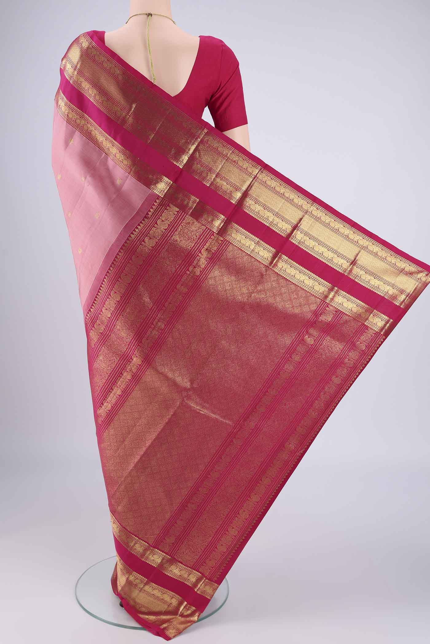 Flat view of Rose Gold Kanchipuram Silk Saree with Zari Butta on the body and Zari Border. 