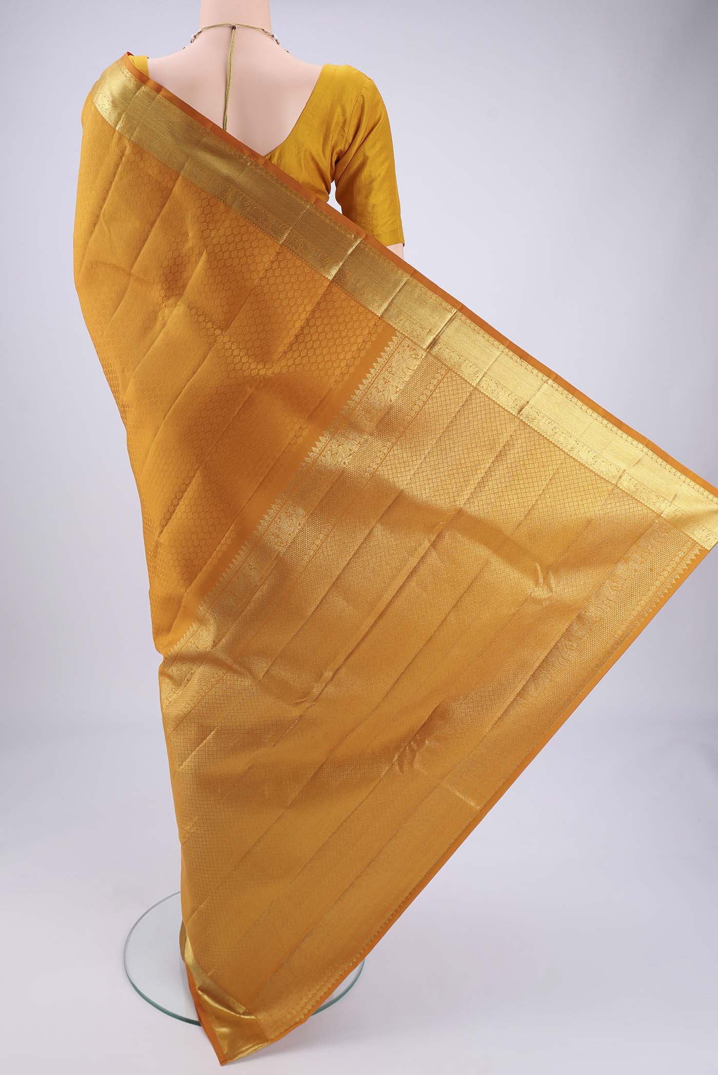 Flat view of Mustard Kanjivaram Silk Saree with Jacquard design on the body and Zari Border. 