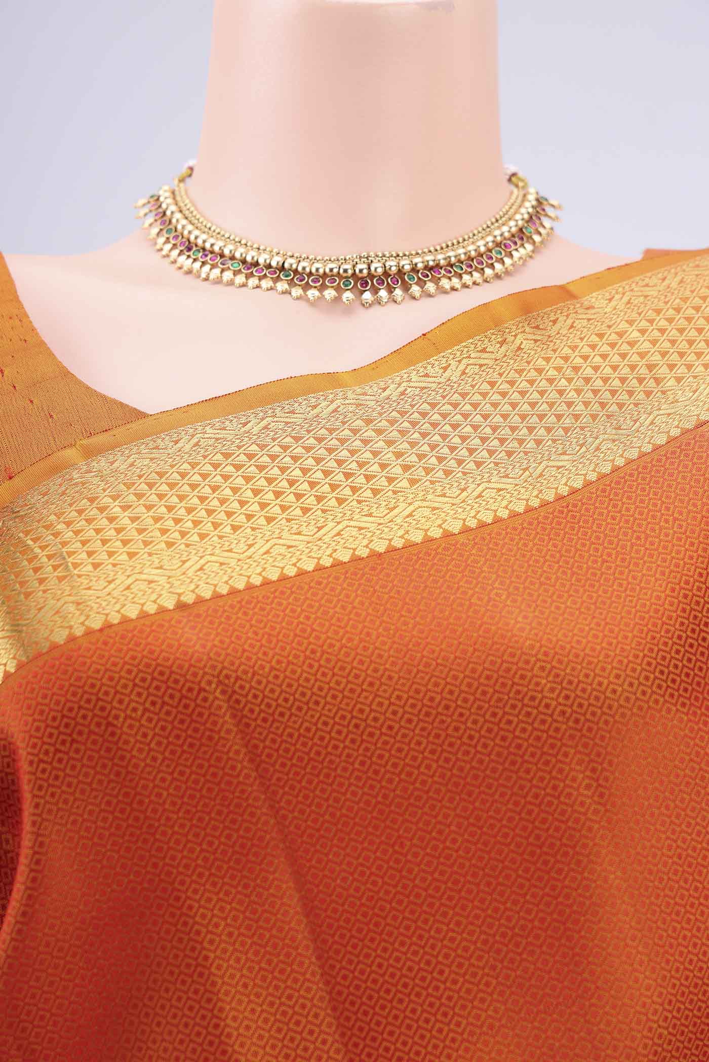 Border image of Rust Kanjivaram Silk Saree with Jacquard design on the body and Zari Border. 