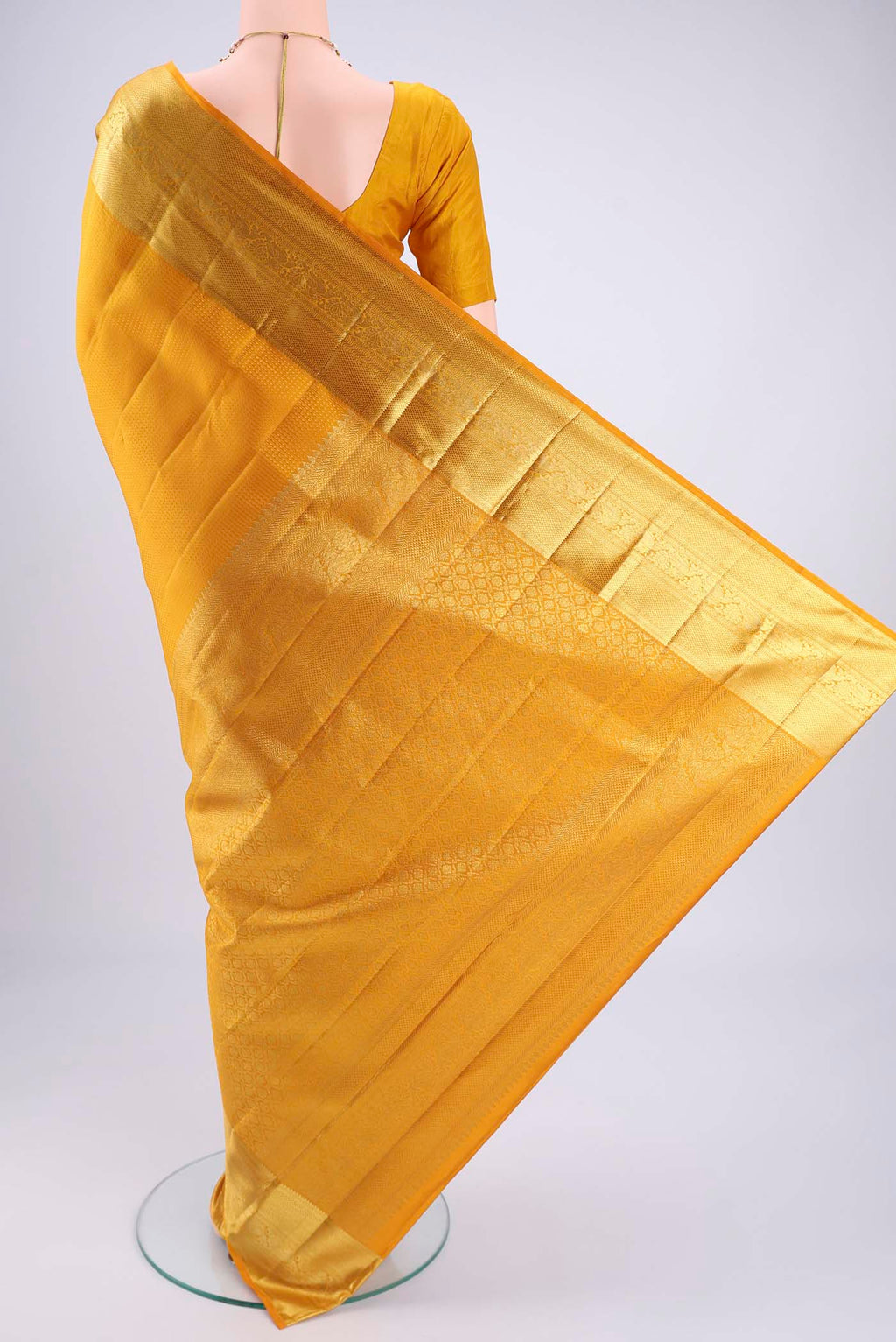 Flat view of Mustard Kanjivaram Silk Saree with Jacquard design on the body and Zari Border. 