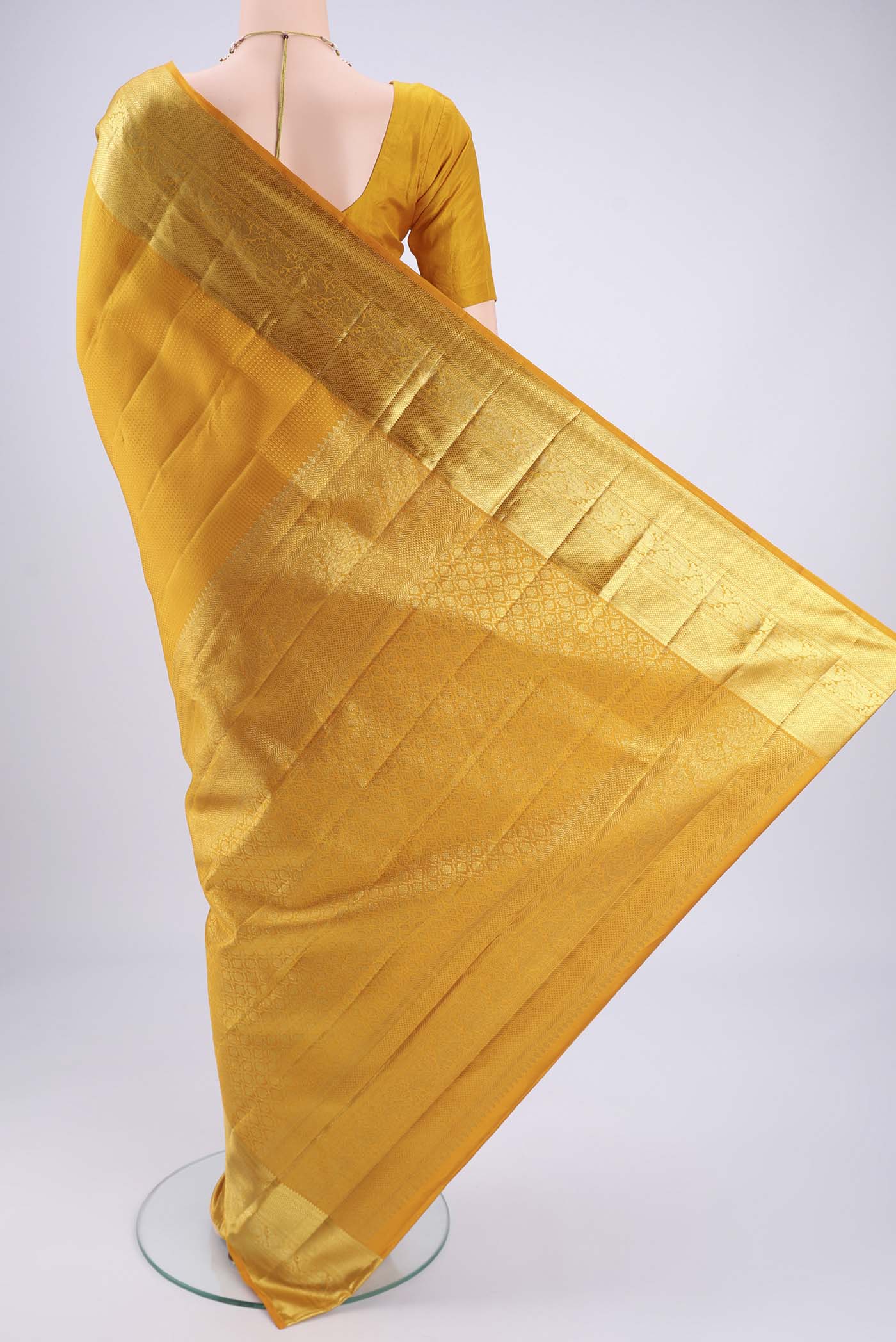 Flat view of Mustard Kanjivaram Silk Saree with Jacquard design on the body and Zari Border. 
