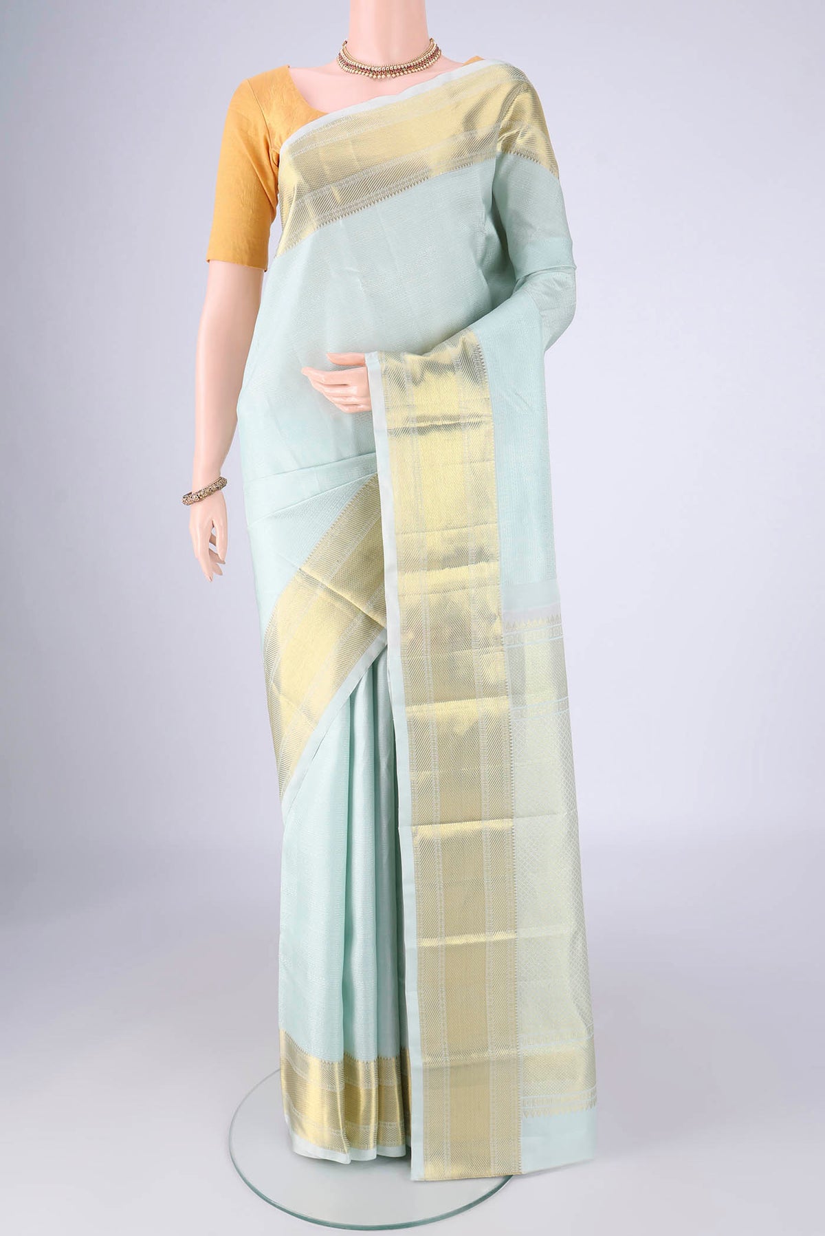 Sky Blue Kanjivaram Silk Saree with Jacquard design on the body and Zari Border.  displayed on a mannequin