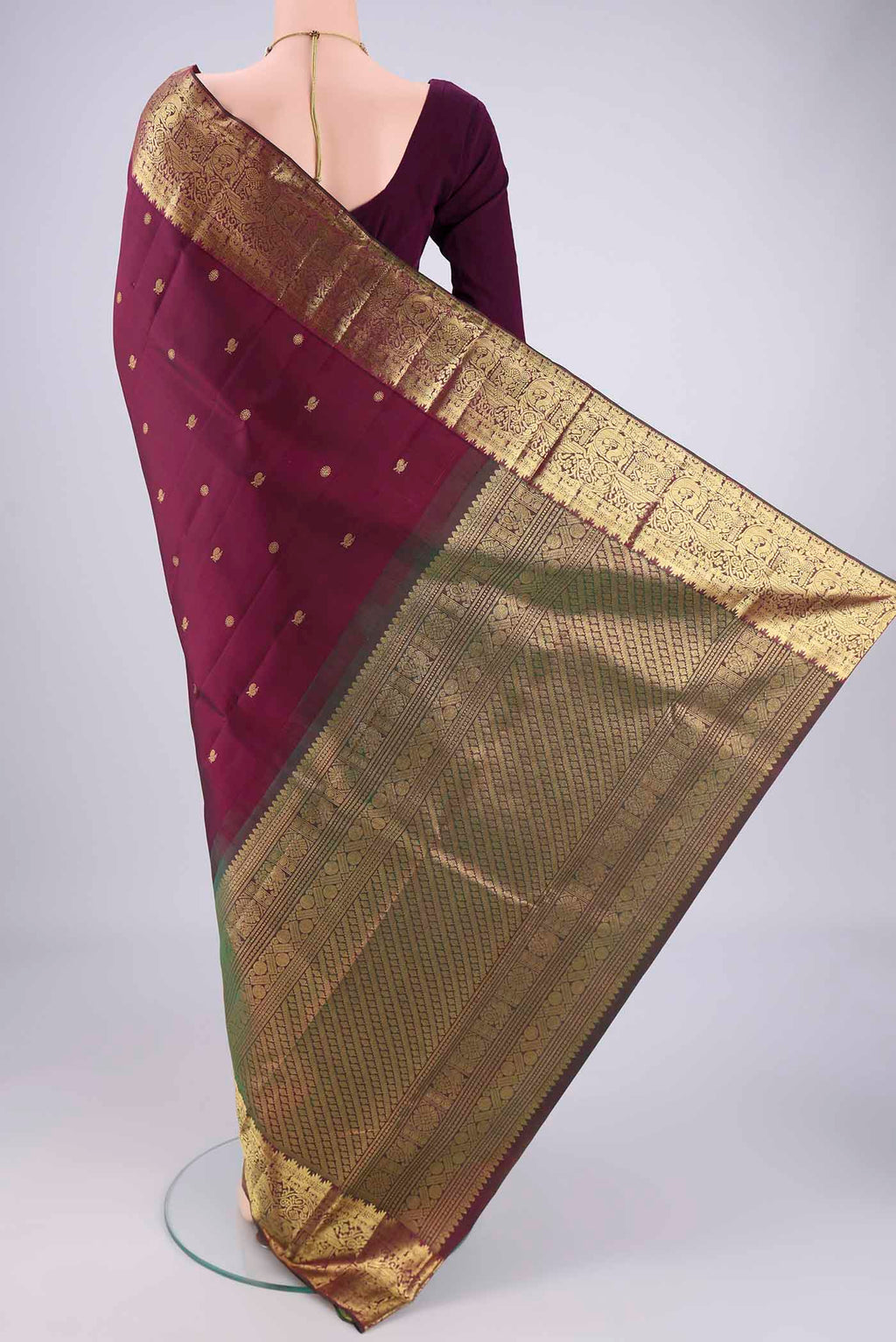 Flat view of Pure Silk Pure Zari Maroon Kanchipuram Saree with Zari Butta on the body and Zari Border. 