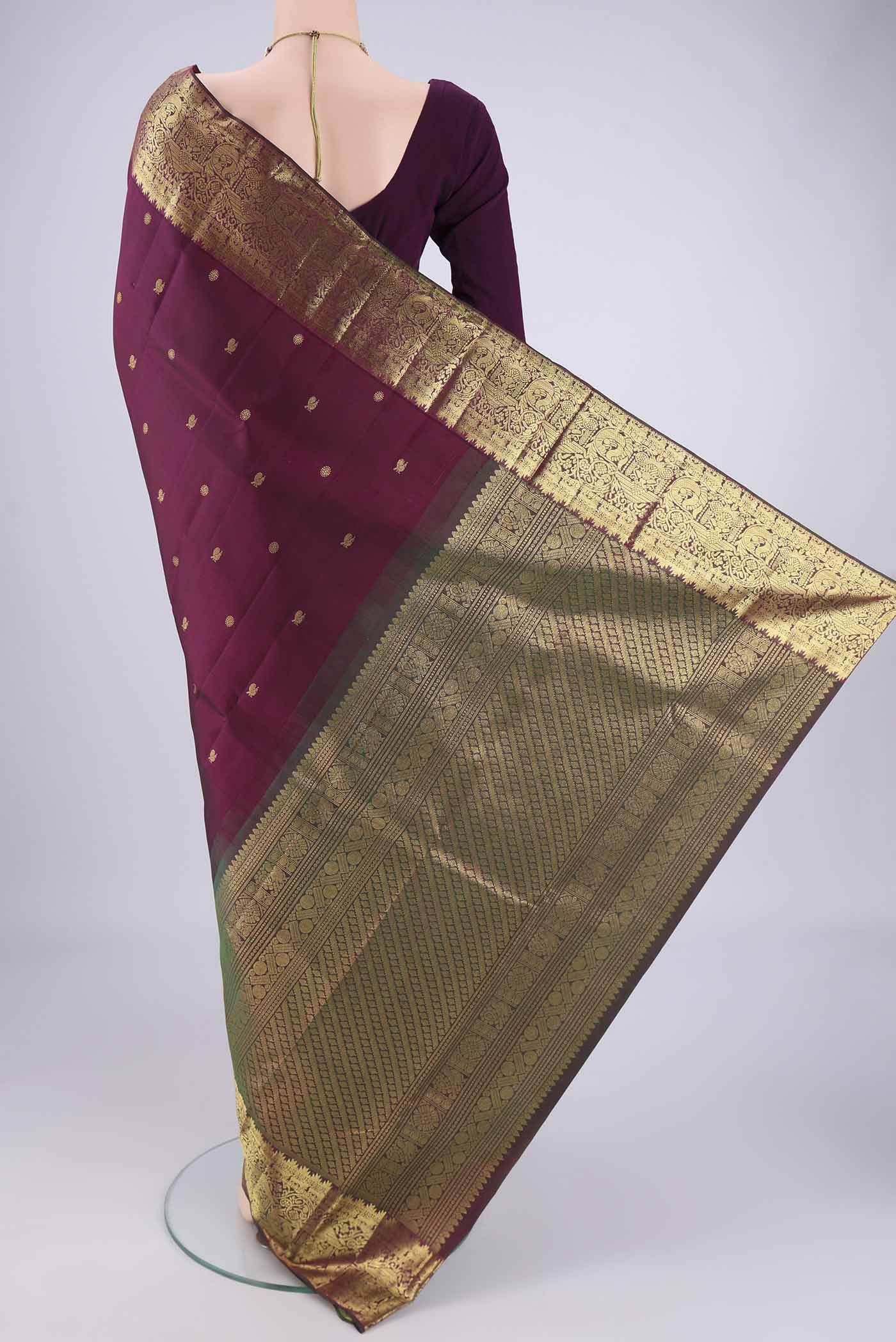 Flat view of Pure Silk Pure Zari Maroon Kanchipuram Saree with Zari Butta on the body and Zari Border. 