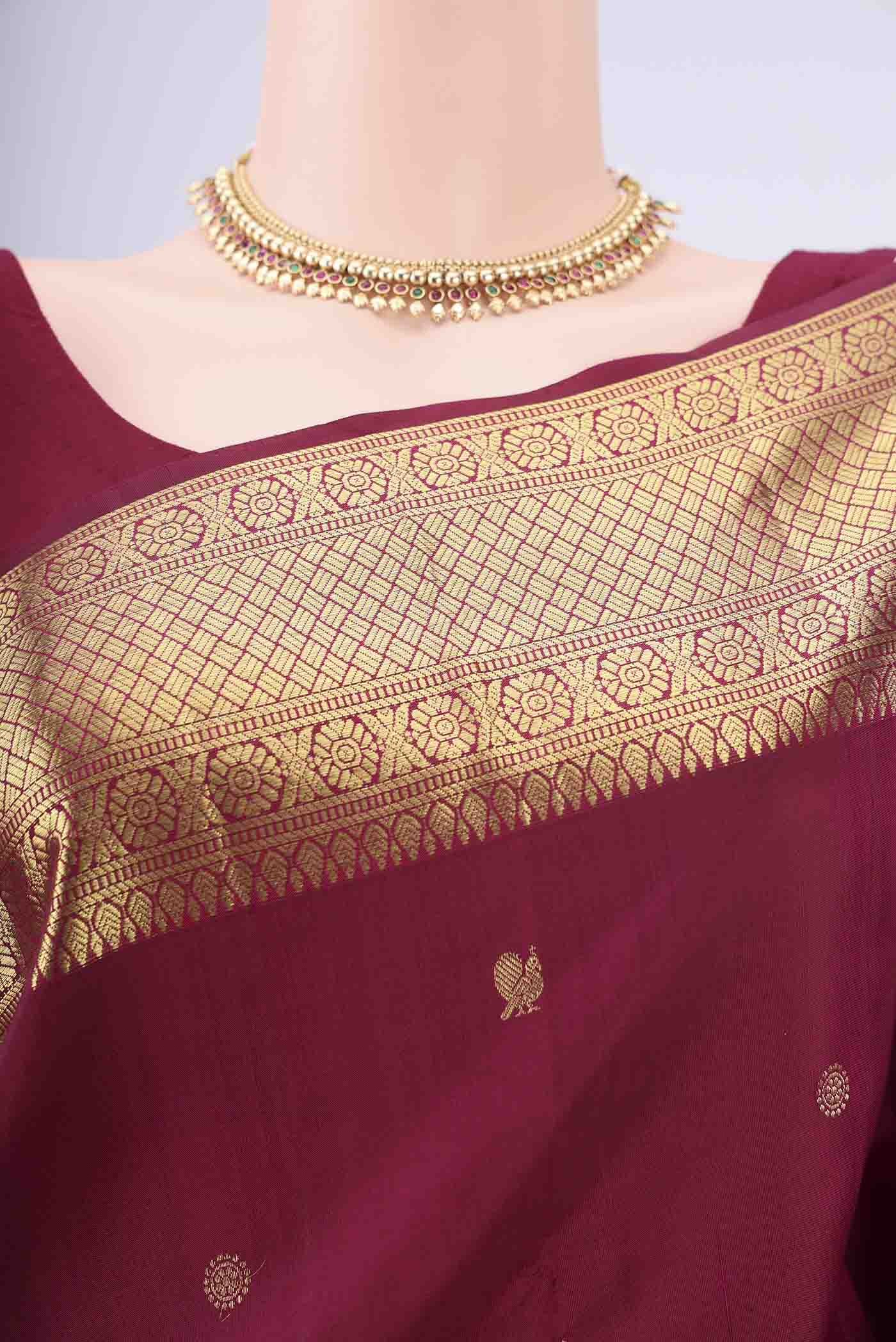 Border image of Maroon Kanchipuram Silk Saree with Zari Butta on the body and Zari Border. 