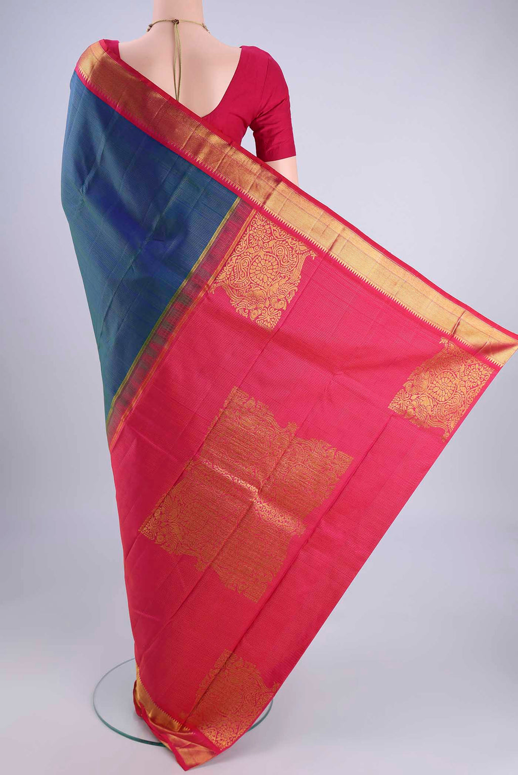 Flat view of Peacock Blue Kanchipuram Silk Saree with Stripes on the body and Zari Border. 